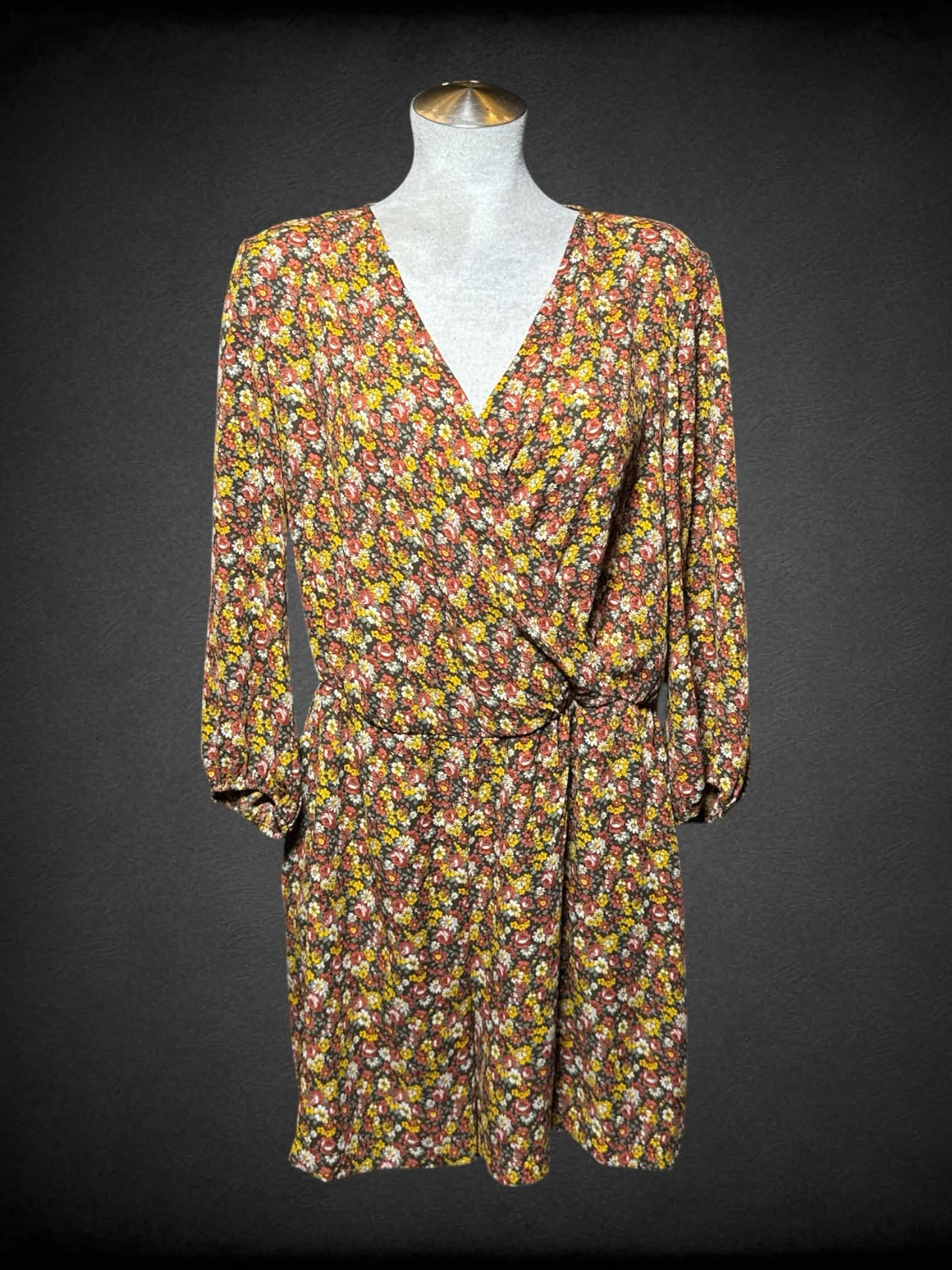 L New York Company brown jumpsuit with yellow & red floral pattern, asymmetrical neck line, and pockets