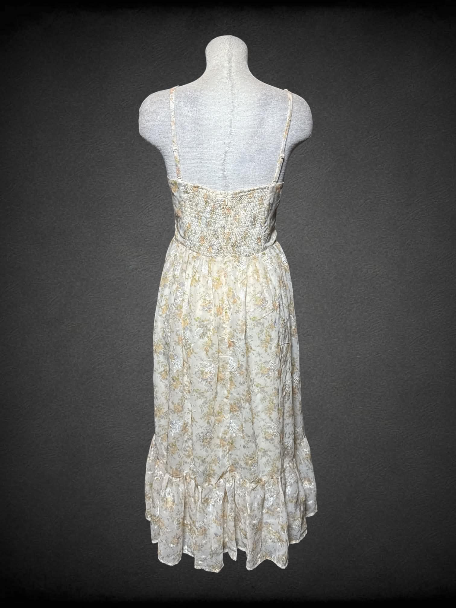 L Storia beige sundress with pastel floral pattern,removable straps, and zipper on back