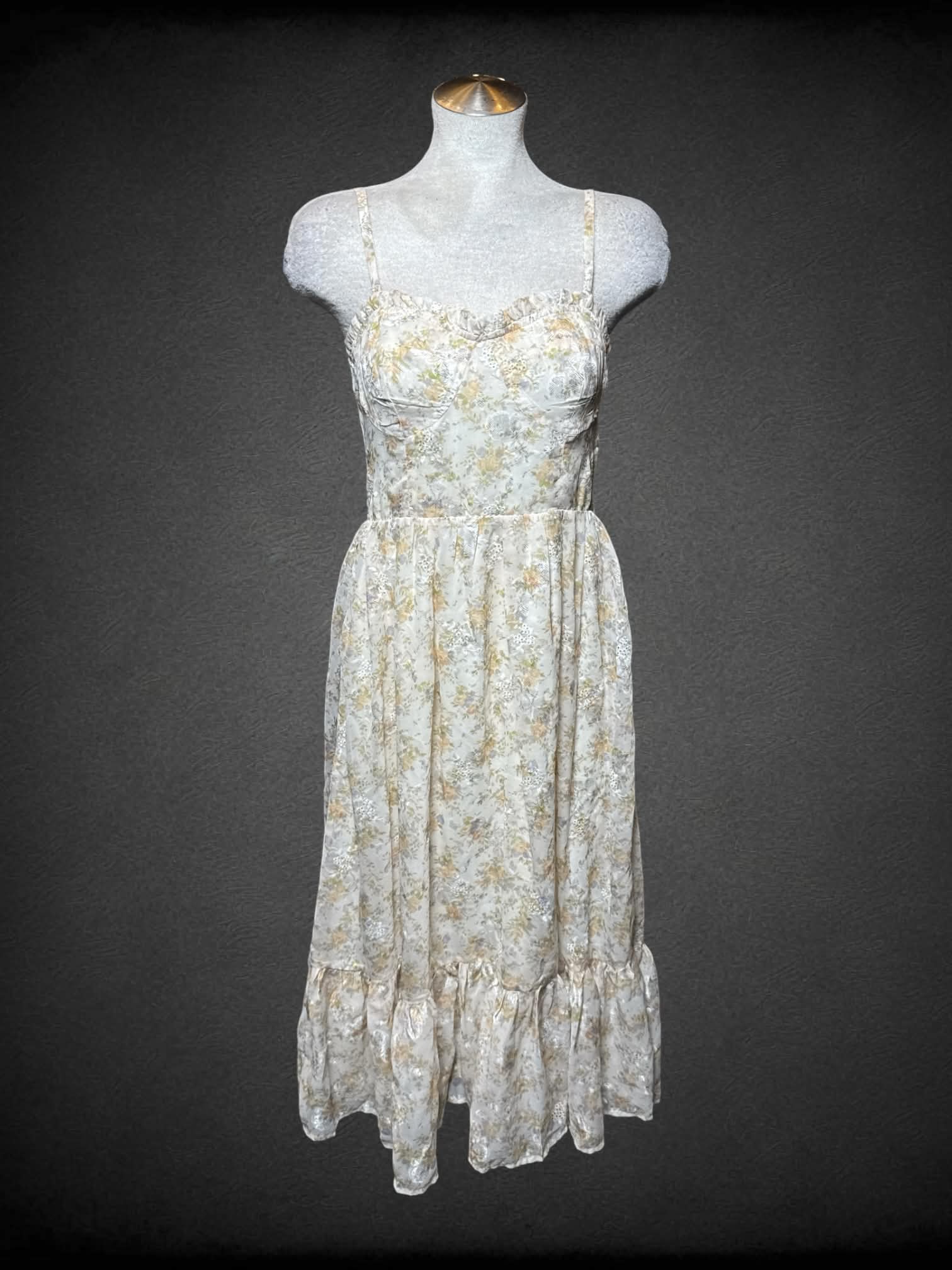 L Storia beige sundress with pastel floral pattern,removable straps, and zipper on back