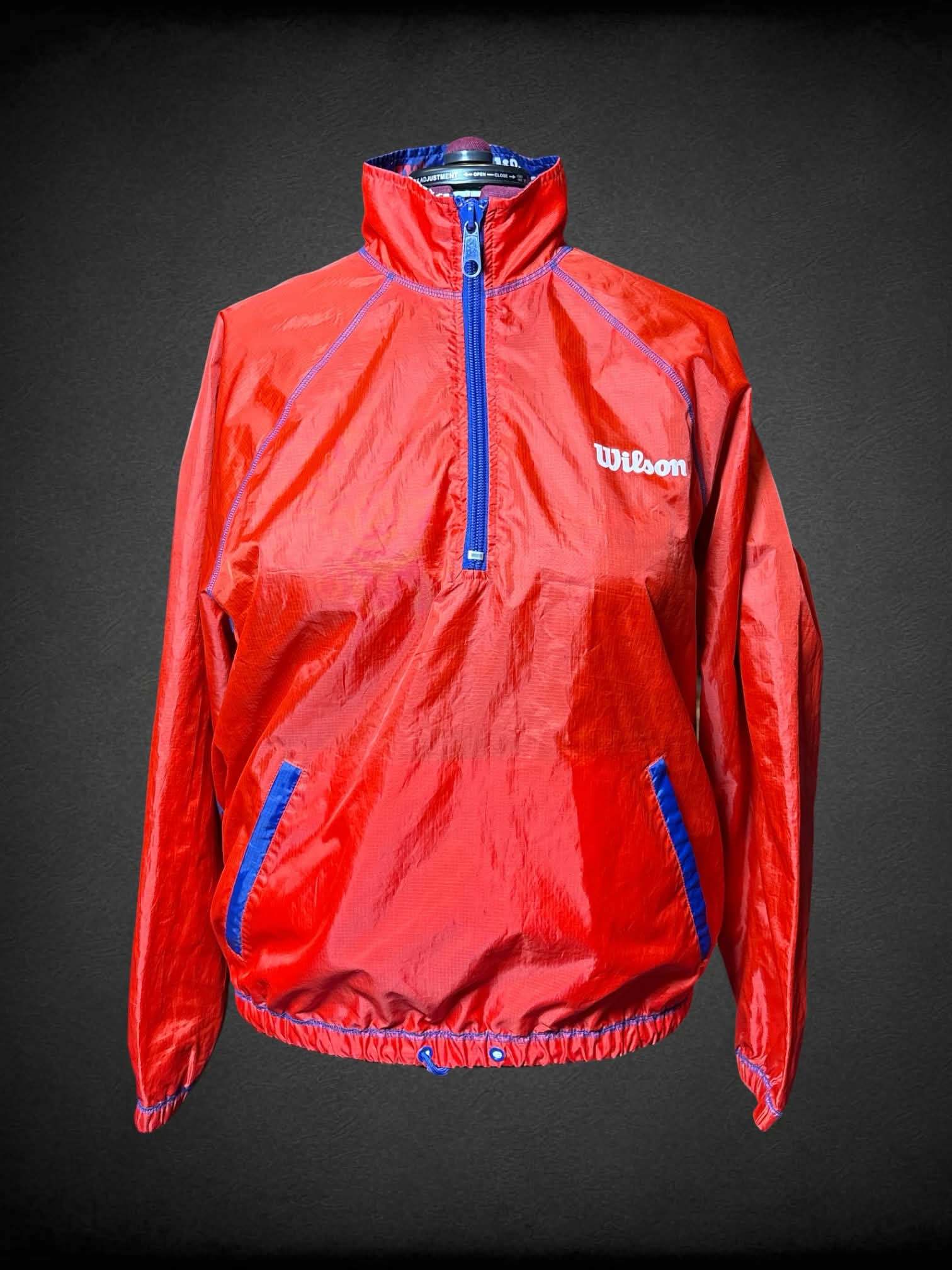 3X Wilson red reversable windbreaker, with blue “Wilson” pattern inside