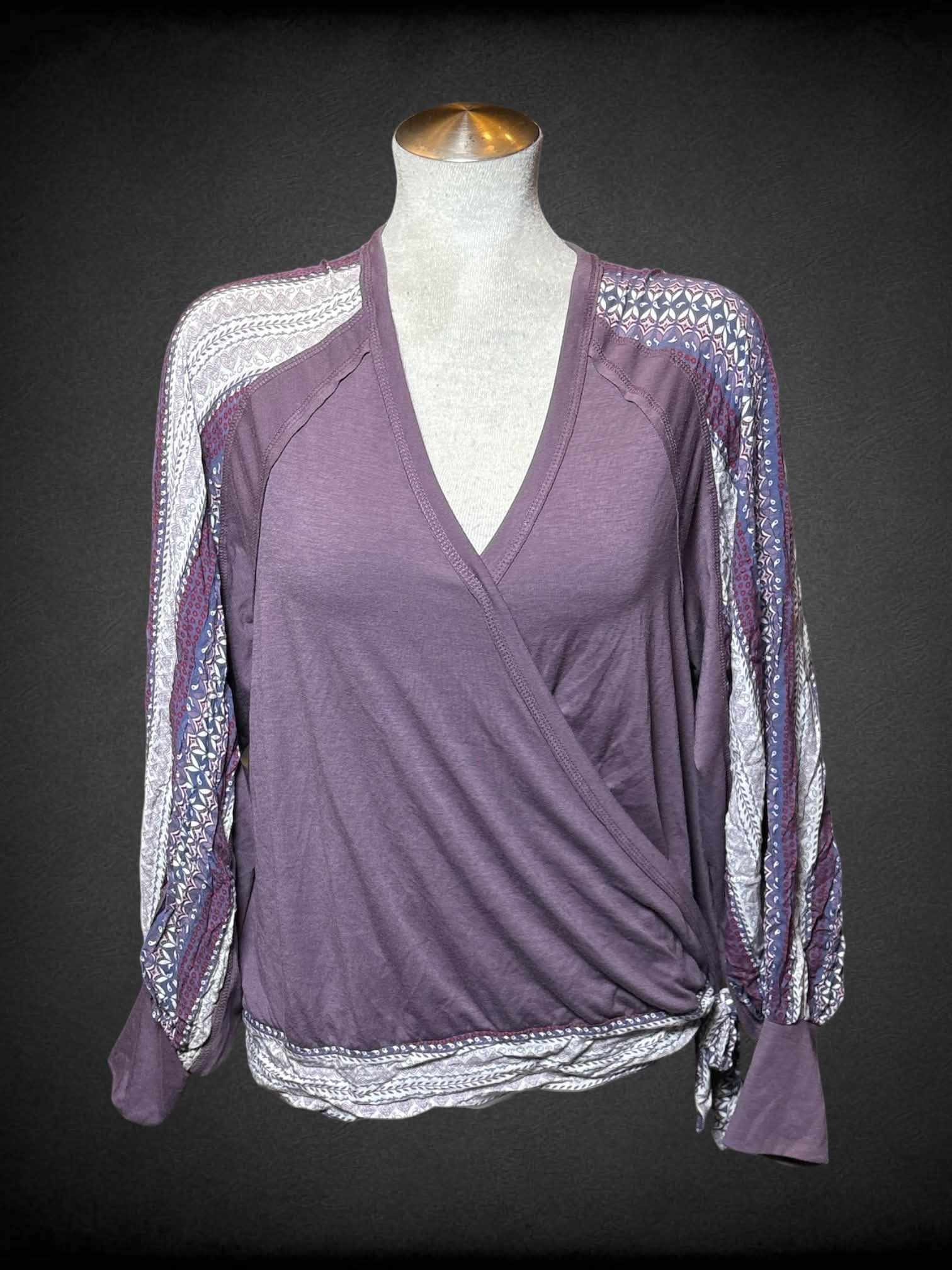 L Cruel purple top with asymmetrical neck line, and paisley-like pattern on sleeves