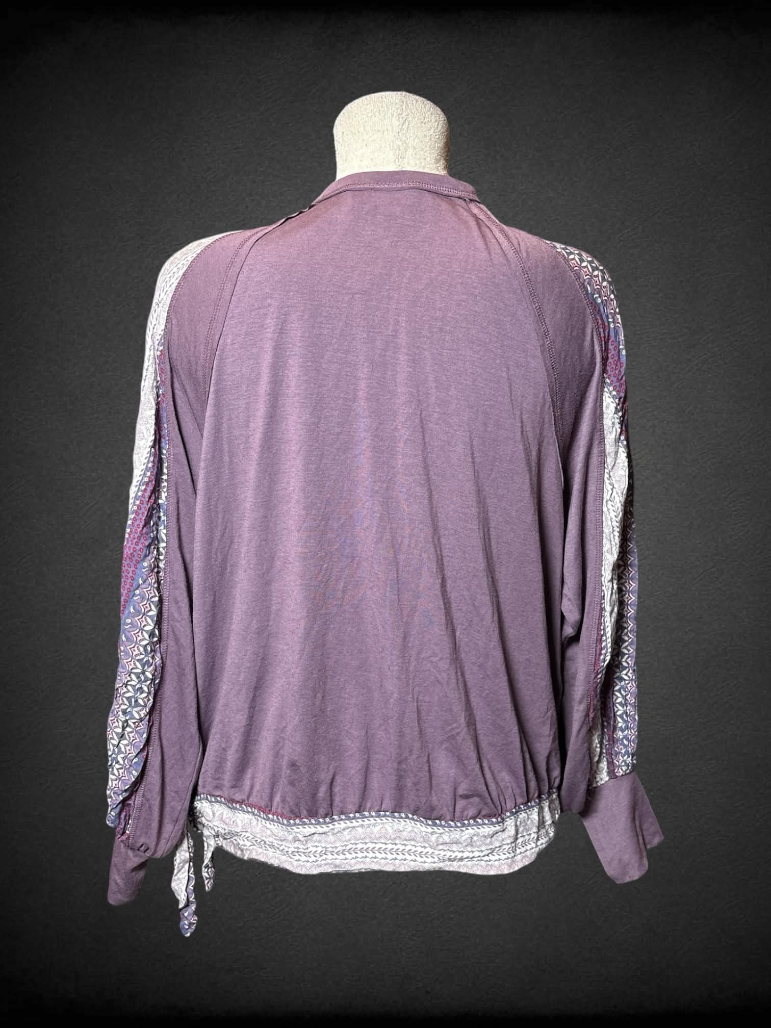 L Cruel purple top with asymmetrical neck line, and paisley-like pattern on sleeves