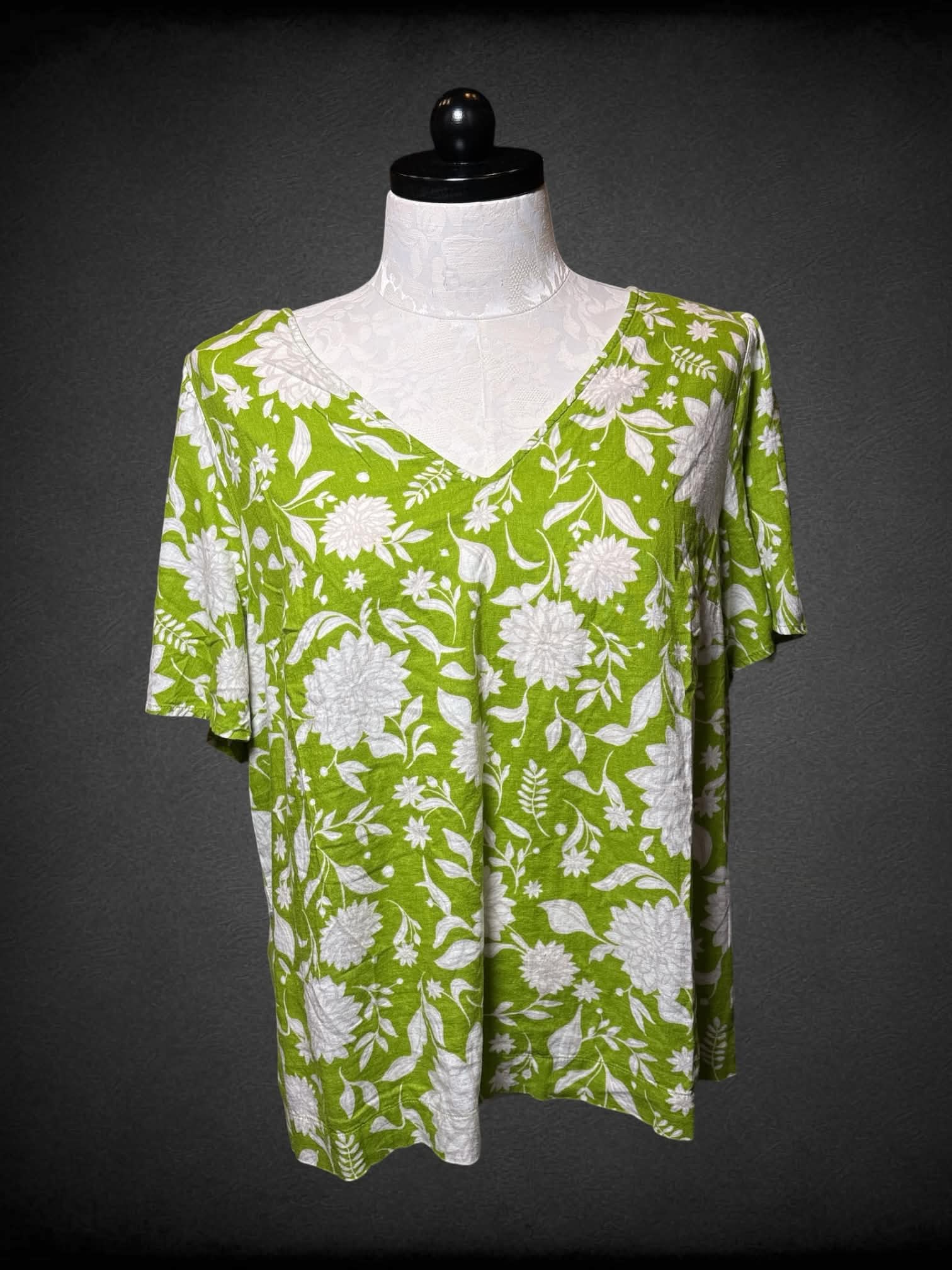 1X Ava Viv green flowy v neck shirt with white floral pattern, and button on back