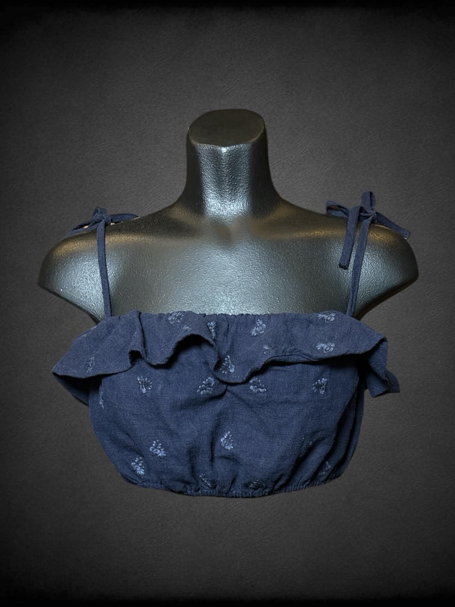 M 4SIENNA navy crop top with embroidered flower pattern, and cinched hem