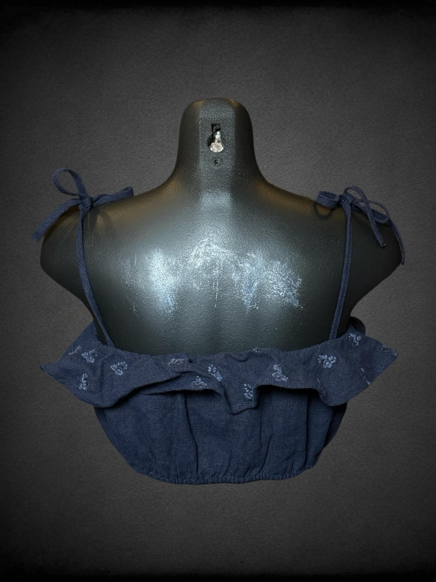 M 4SIENNA navy crop top with embroidered flower pattern, and cinched hem