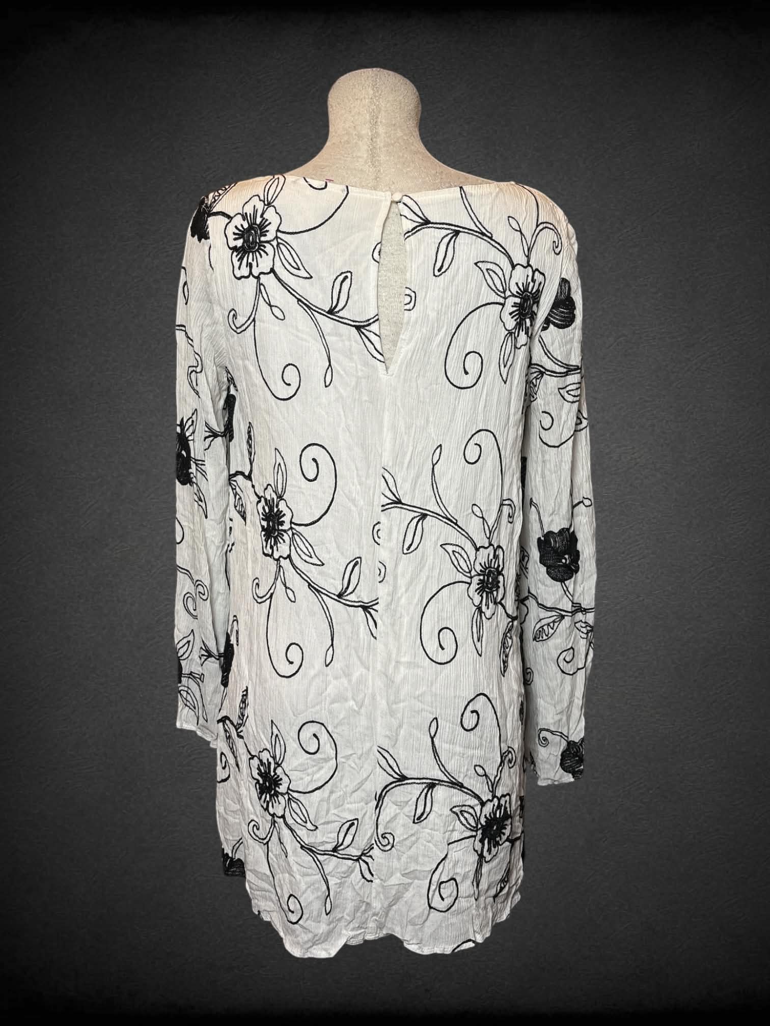 L Rokoko by Dazz white longsleeve dress with black woven flower design, and button on pack
