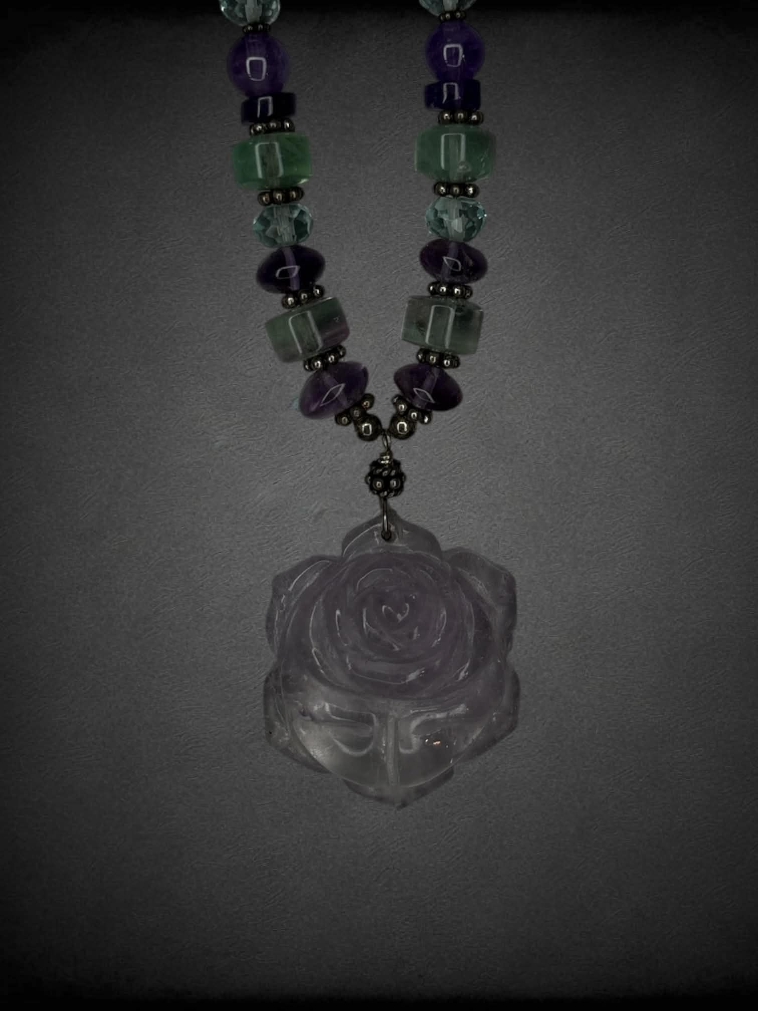 Purple beaded necklace with rose charm