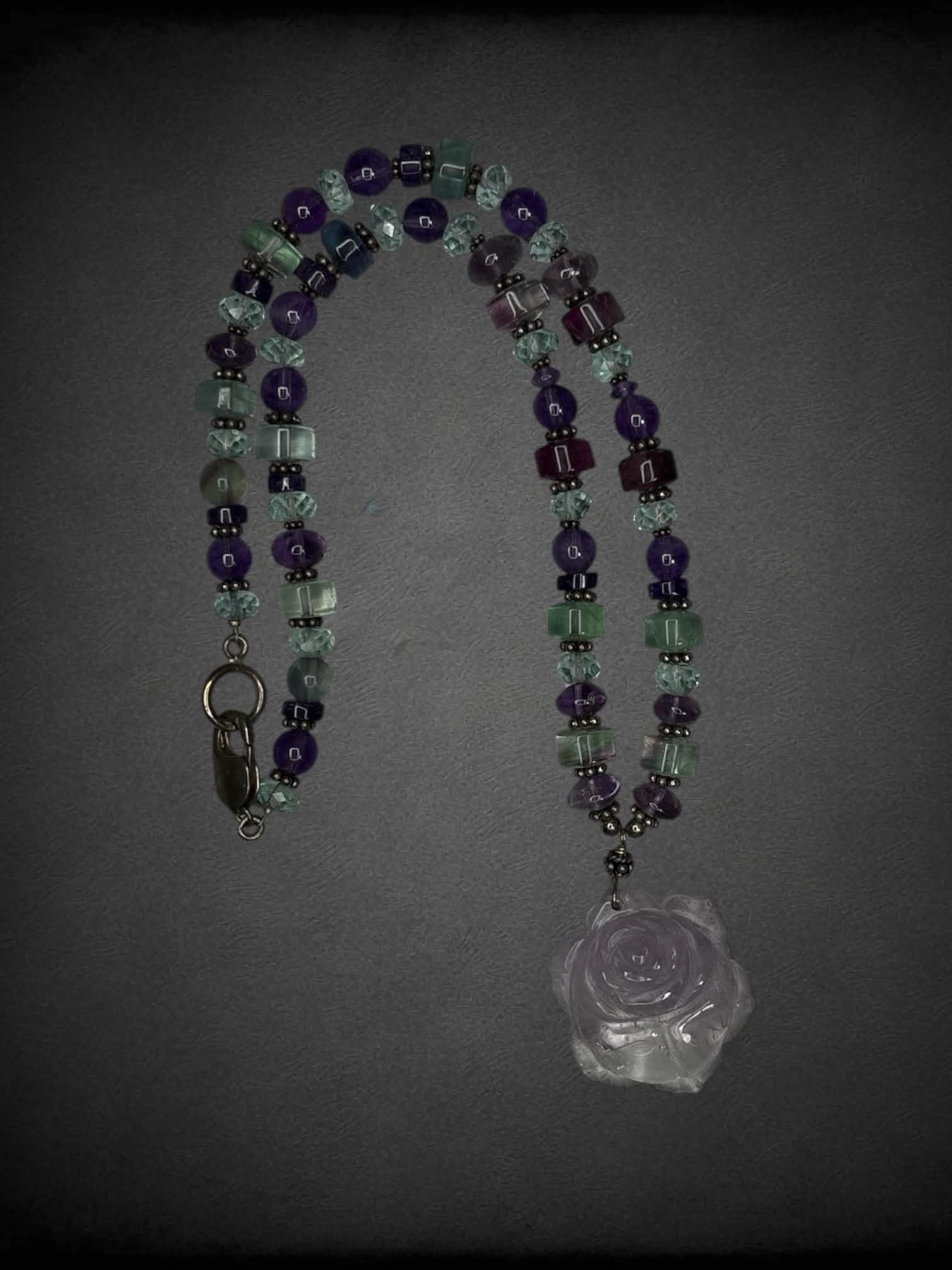 Purple beaded necklace with rose charm