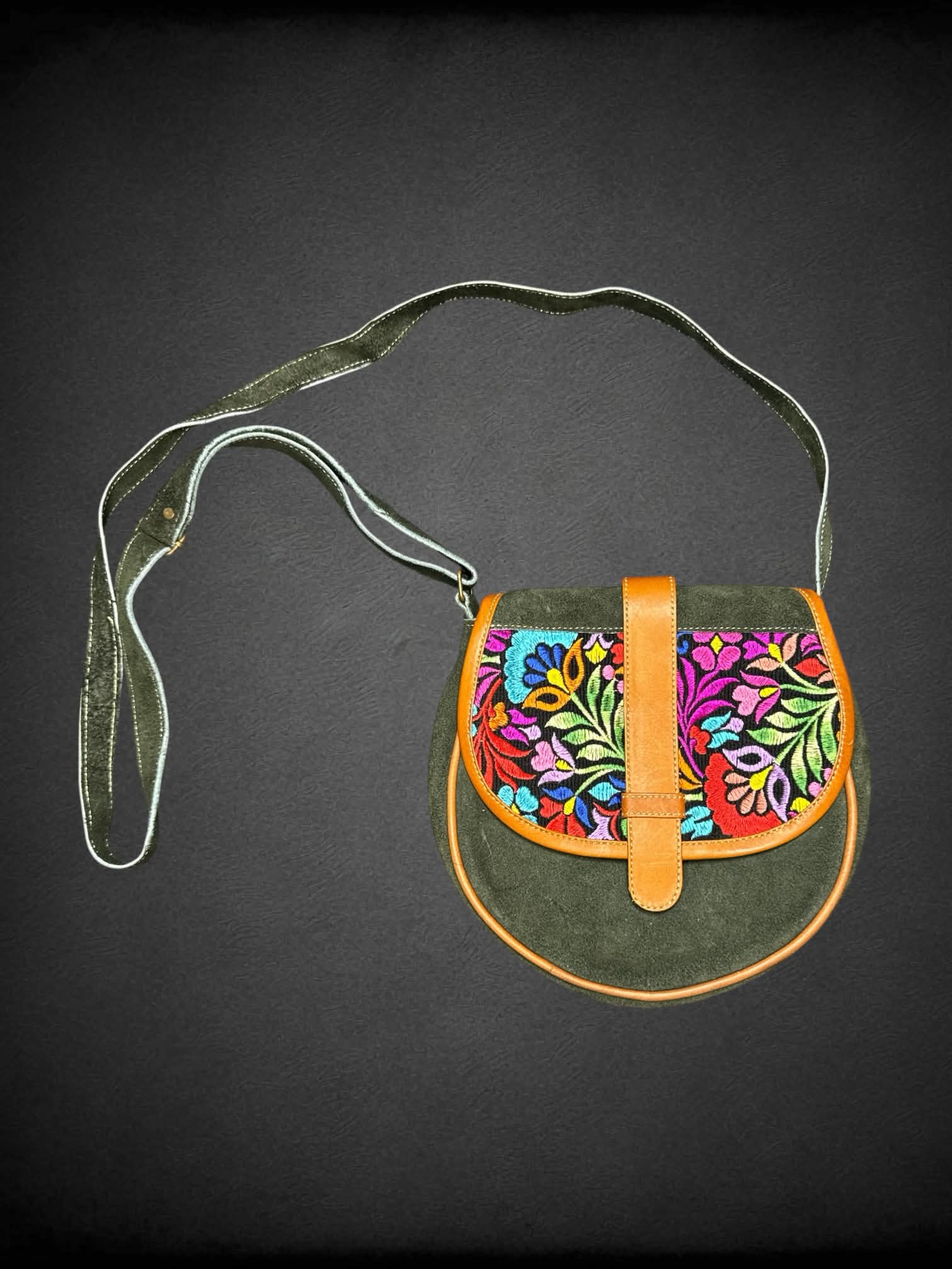 Green suede shoulder bag with embroidered flower design, and zipper pockets on front & back