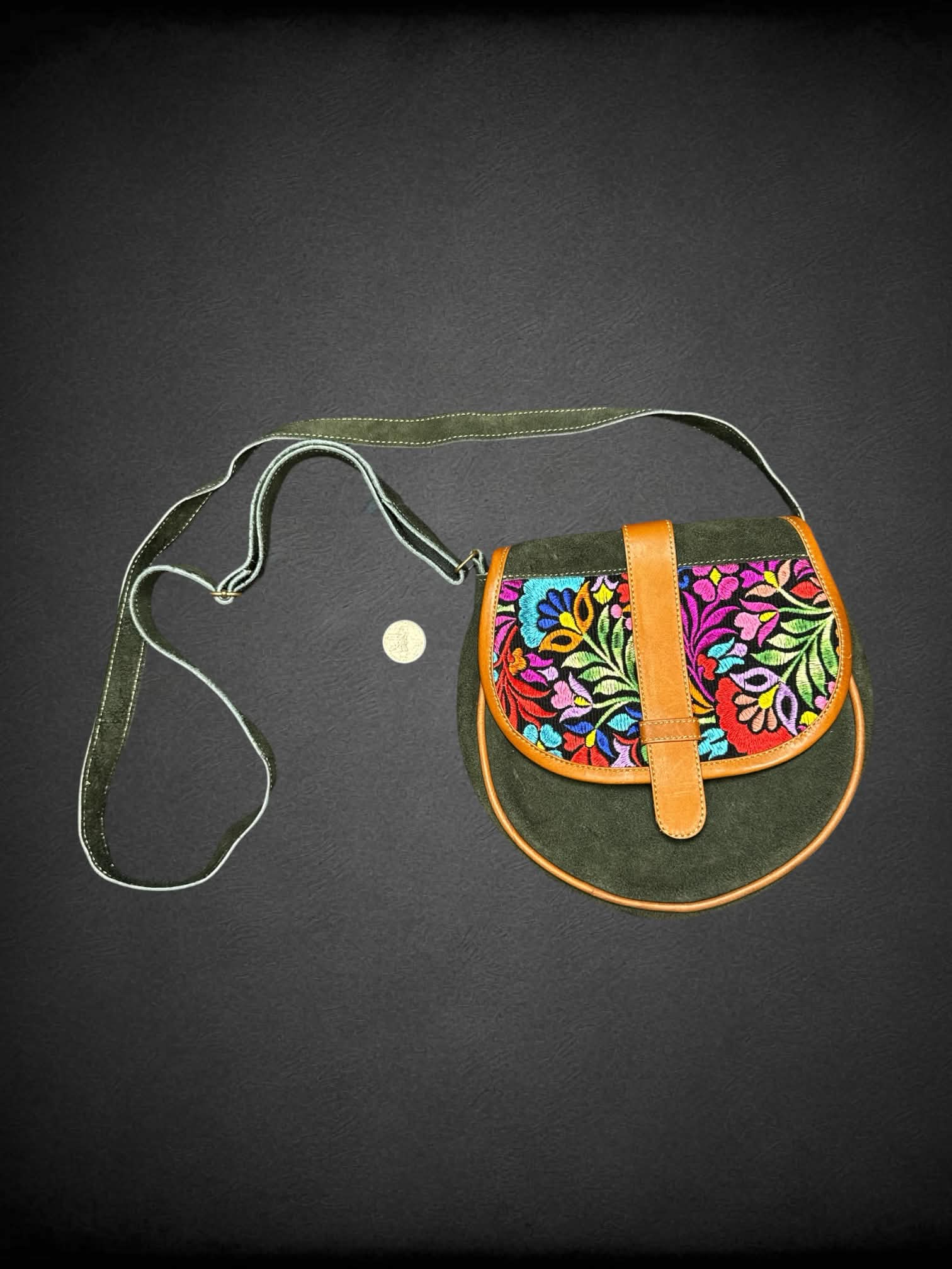 Green suede shoulder bag with embroidered flower design, and zipper pockets on front & back
