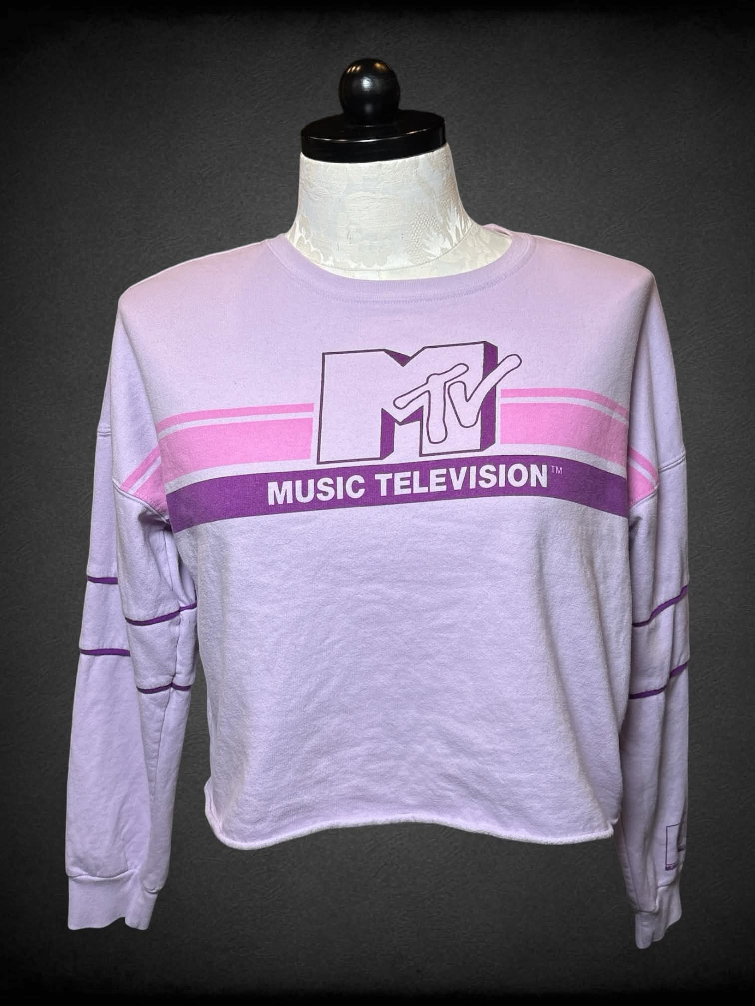 0X MTV pastel purple long-sleeve shirt with “MTV” graphic on front, and “MTV” logo on sleeve