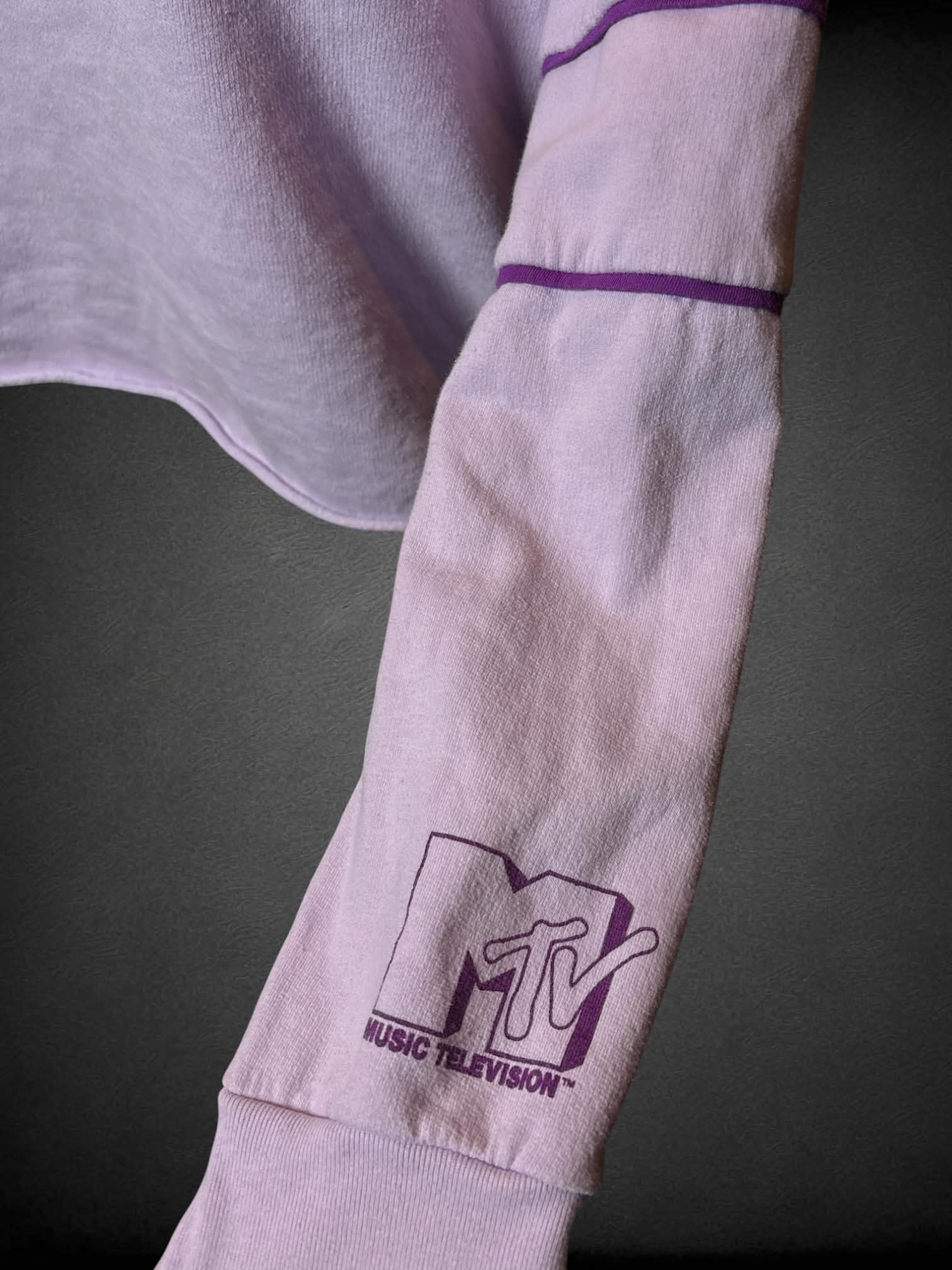 0X MTV pastel purple long-sleeve shirt with “MTV” graphic on front, and “MTV” logo on sleeve