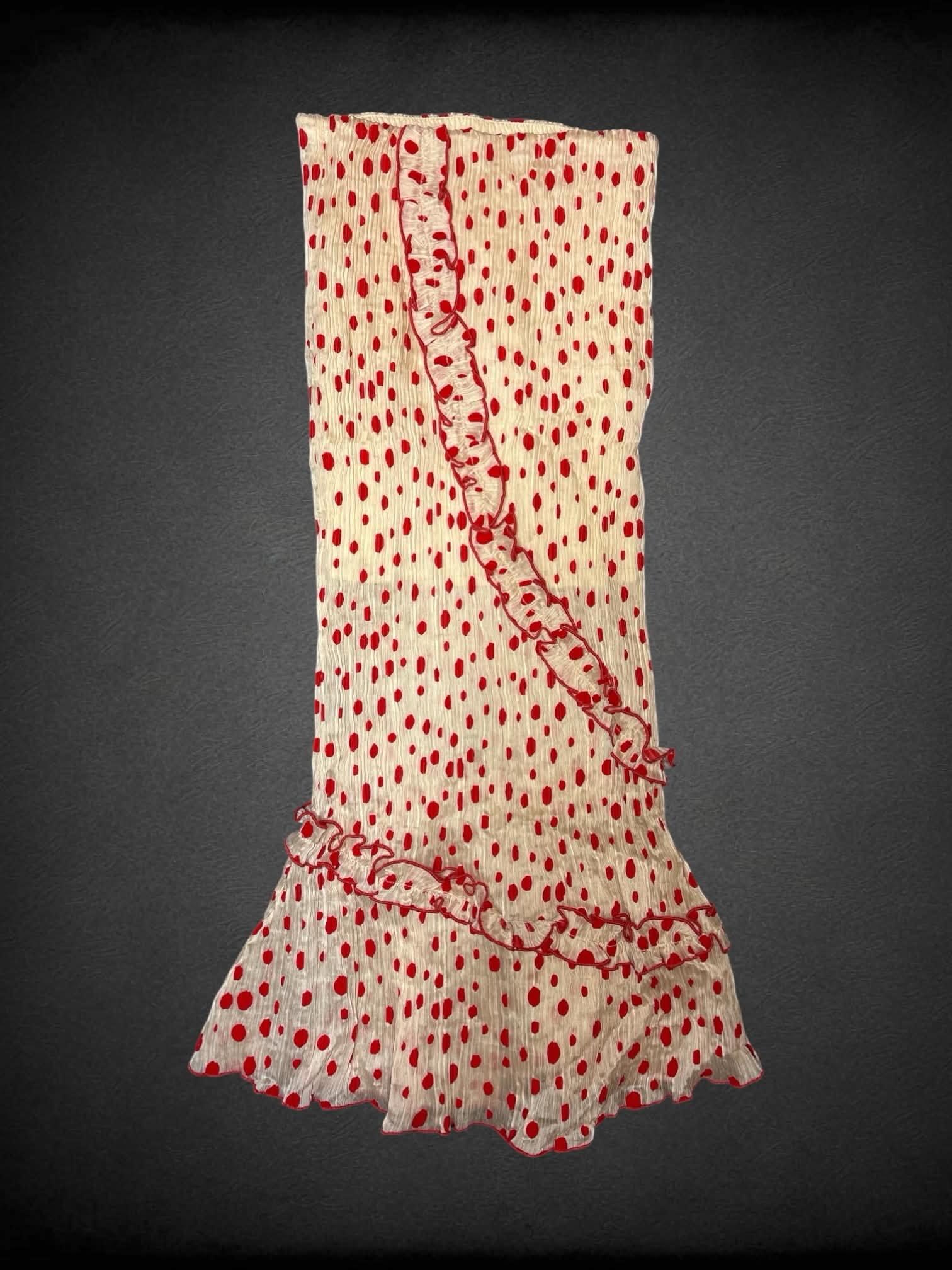 M Tattletale off-white pleated pleated maxi skirt with red polka dot pattern, stretch waist and asymmetrical ruffle cut on front