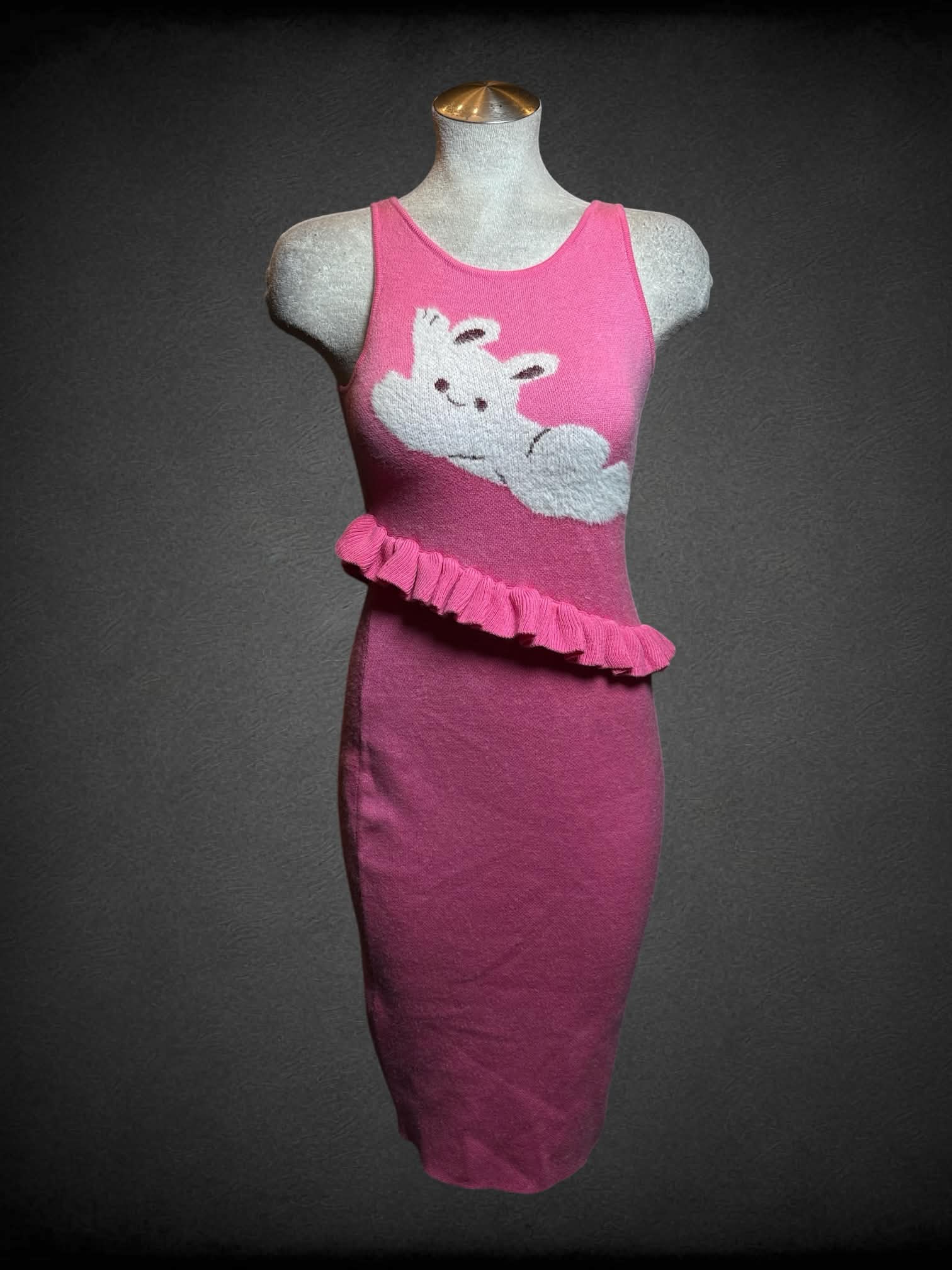 L Tattletale pink soft dress with asymmetrical ruffle hem, white bunny graphic on front, and slit on skirt