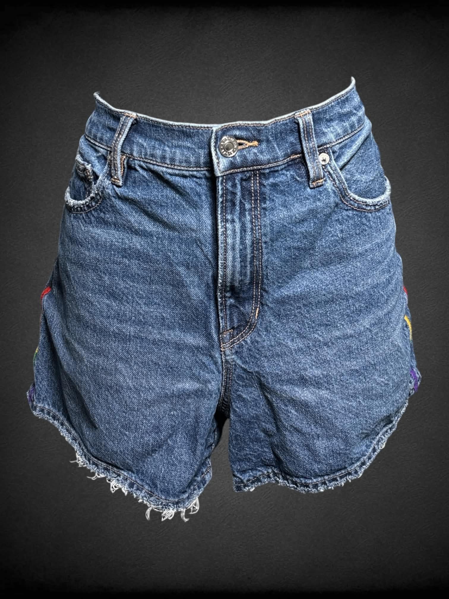 M American Eagle blue denim shorts with embroidered Pride colors on each side
