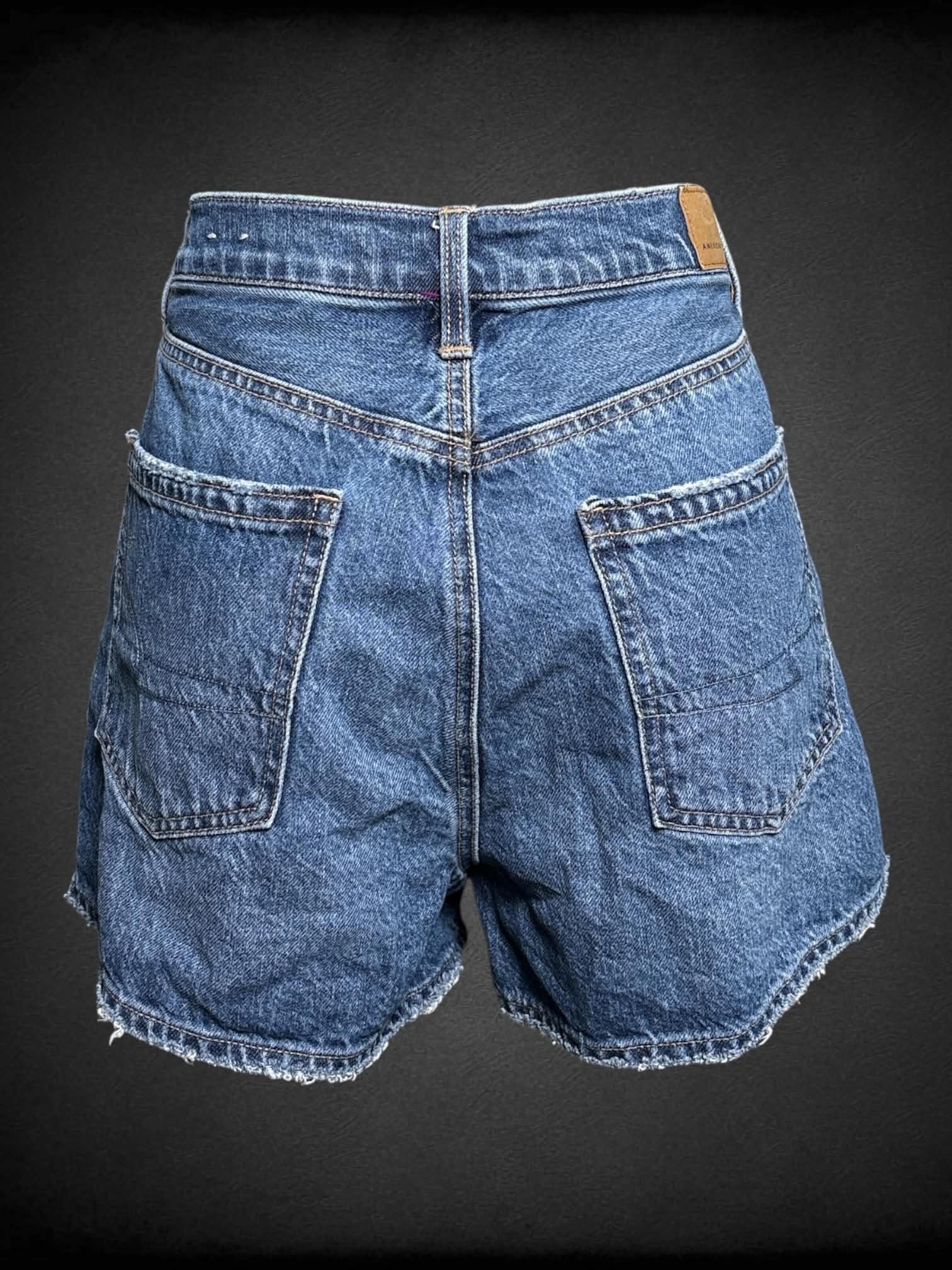 M American Eagle blue denim shorts with embroidered Pride colors on each side