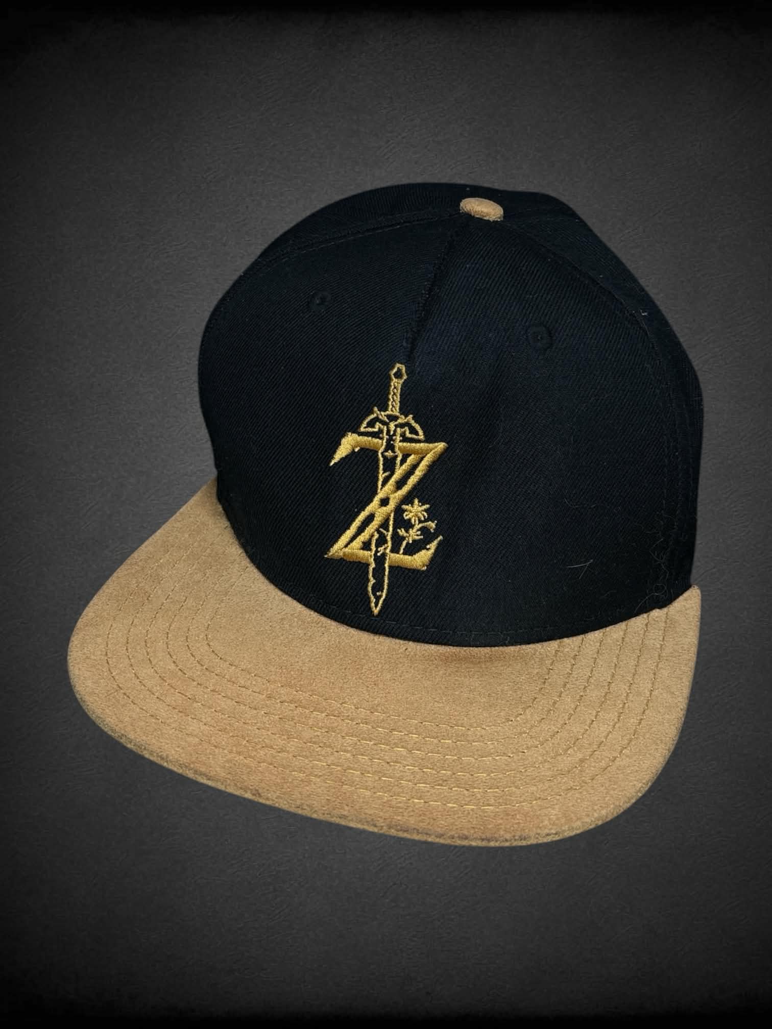 Black snapback hat with embroidered “Legend of Zelda” logo on front