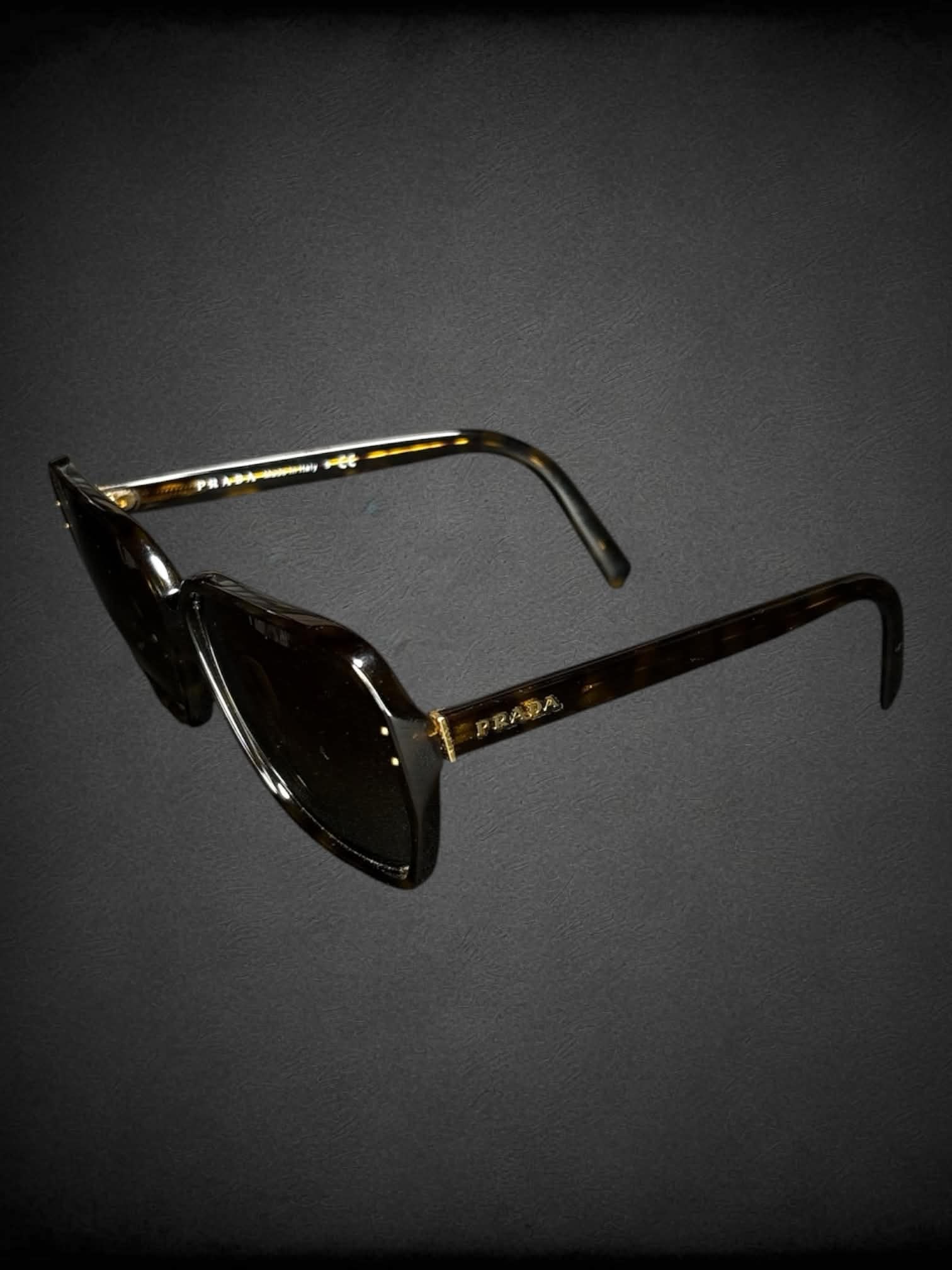 Prada SPR 16M sunglasses with polarized brown gradient lenses and Havana tortoiseshell frames