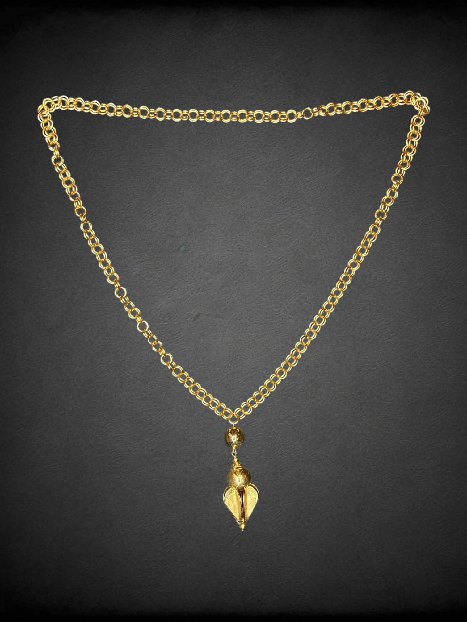 Vintage gold chain with ornamental charm