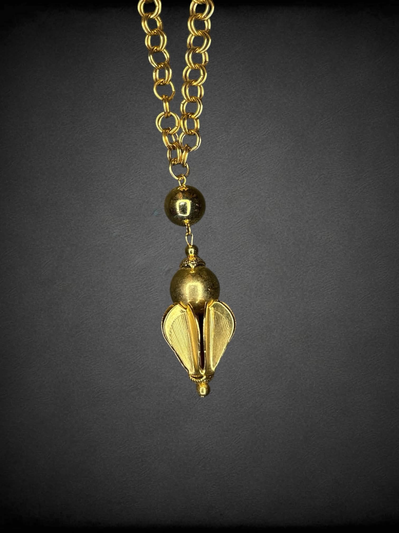 Vintage gold chain with ornamental charm