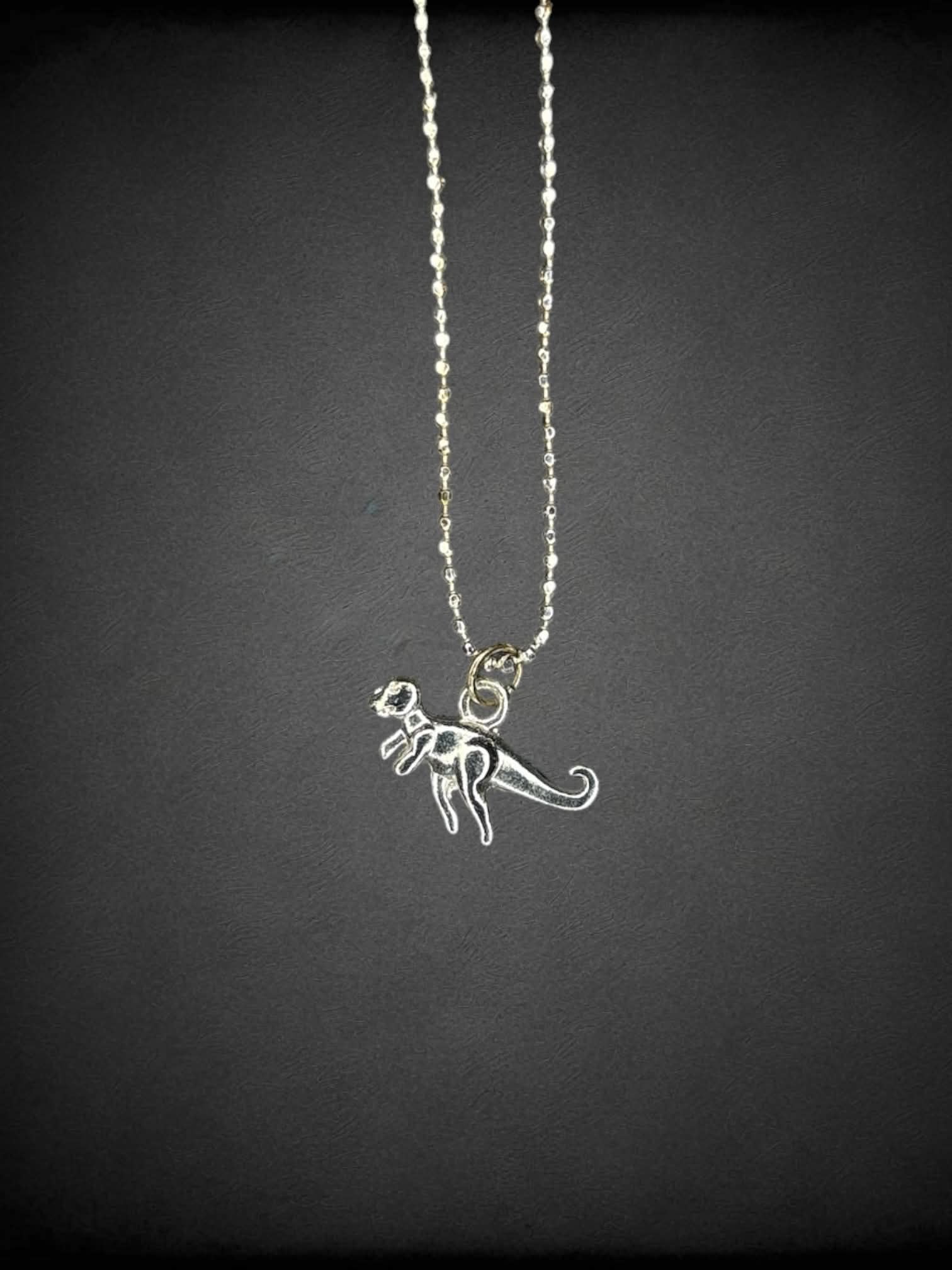 Silver chain necklace with tiny t-Rex charm