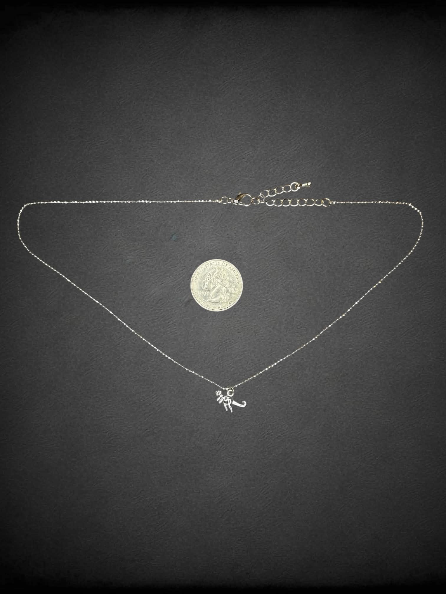 Silver chain necklace with tiny t-Rex charm