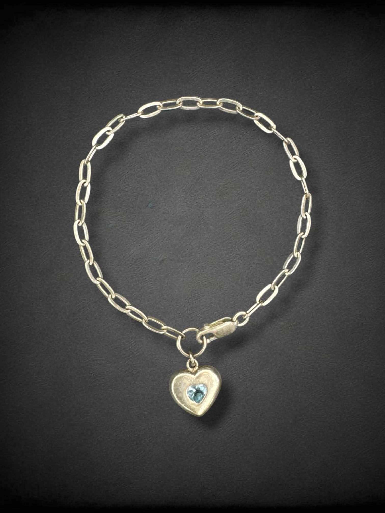 Chain link adjustable bracelet with light blue jeweled heart charm