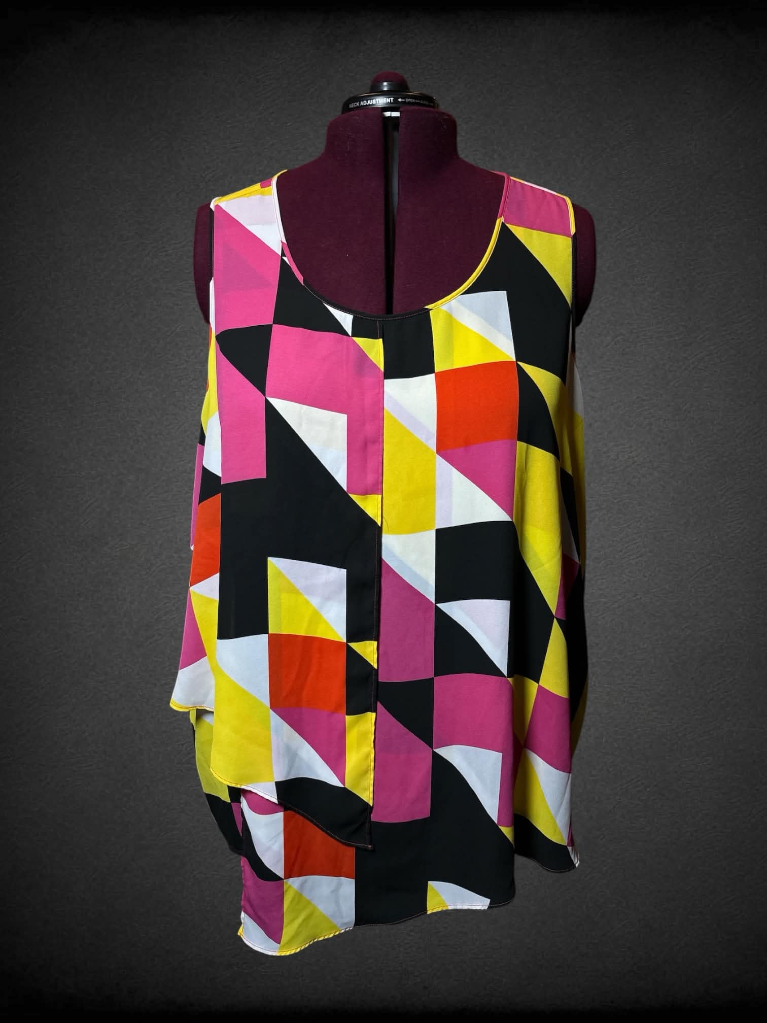 5X Ashley Stewart pink flowy blouse with black, white & yellow triangular pattern, and asymmetrical cut