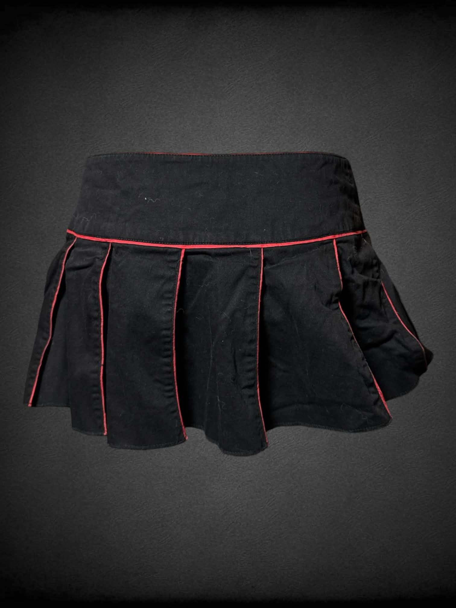 L Tripp NYC black pleated mini skirt with red trimming, and buttons going up side