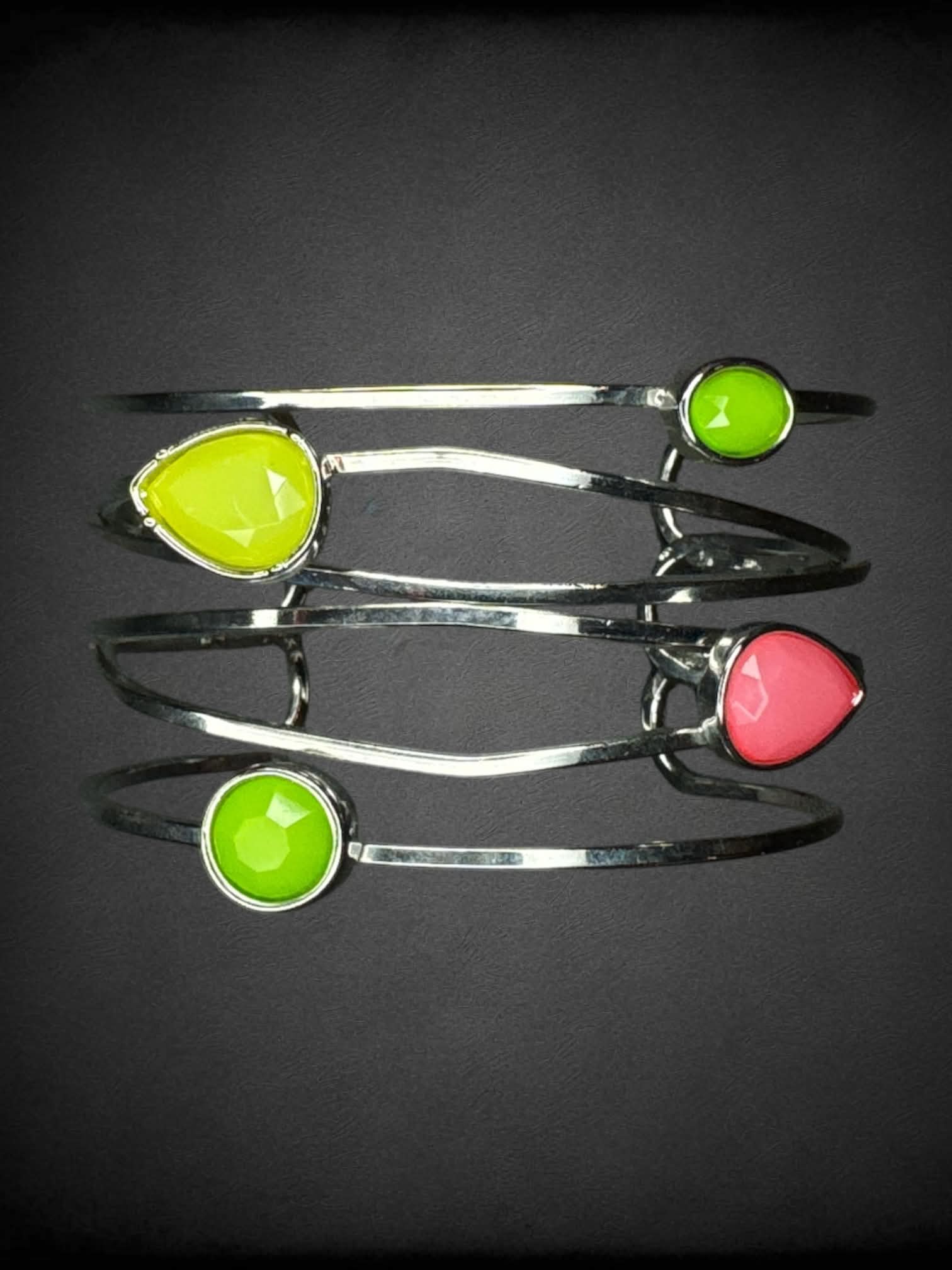 Silver bangle bracelet with green and pink gems