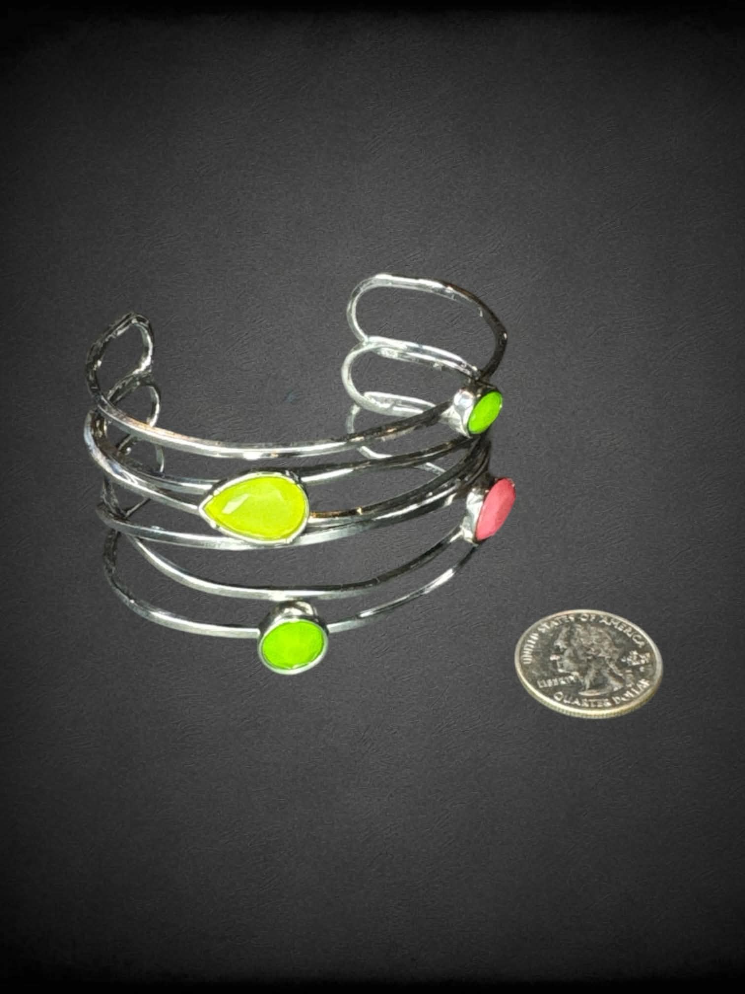 Silver bangle bracelet with green and pink gems