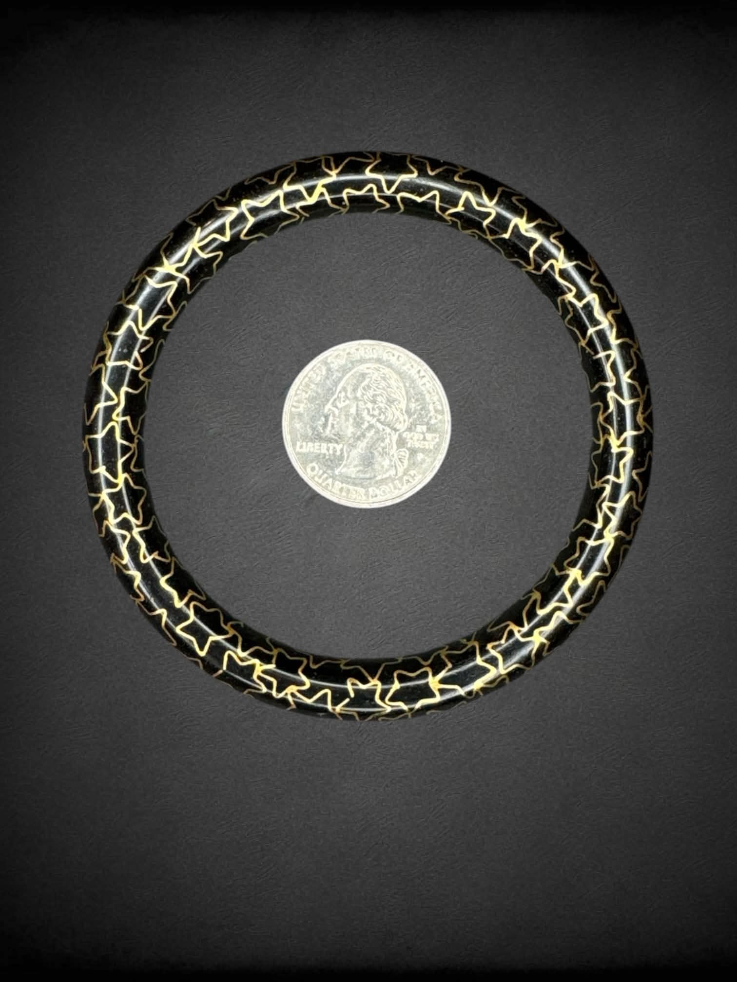 Black bangle bracelet with gold star pattern