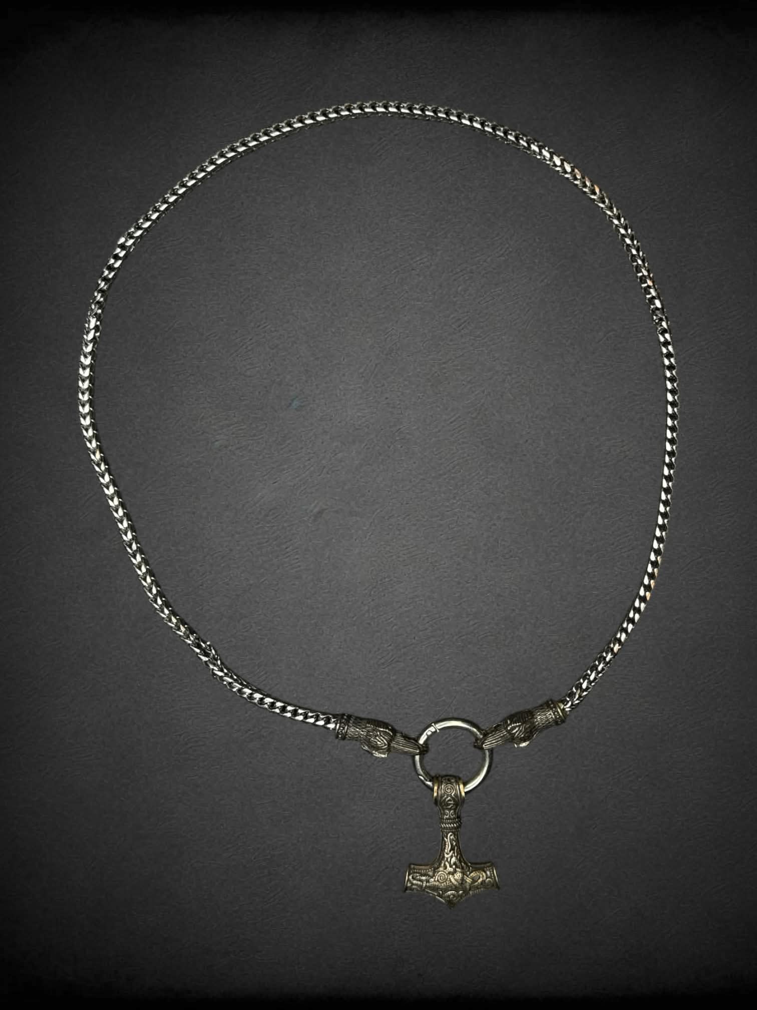 Heavy silver chain with anchor and bird head charms