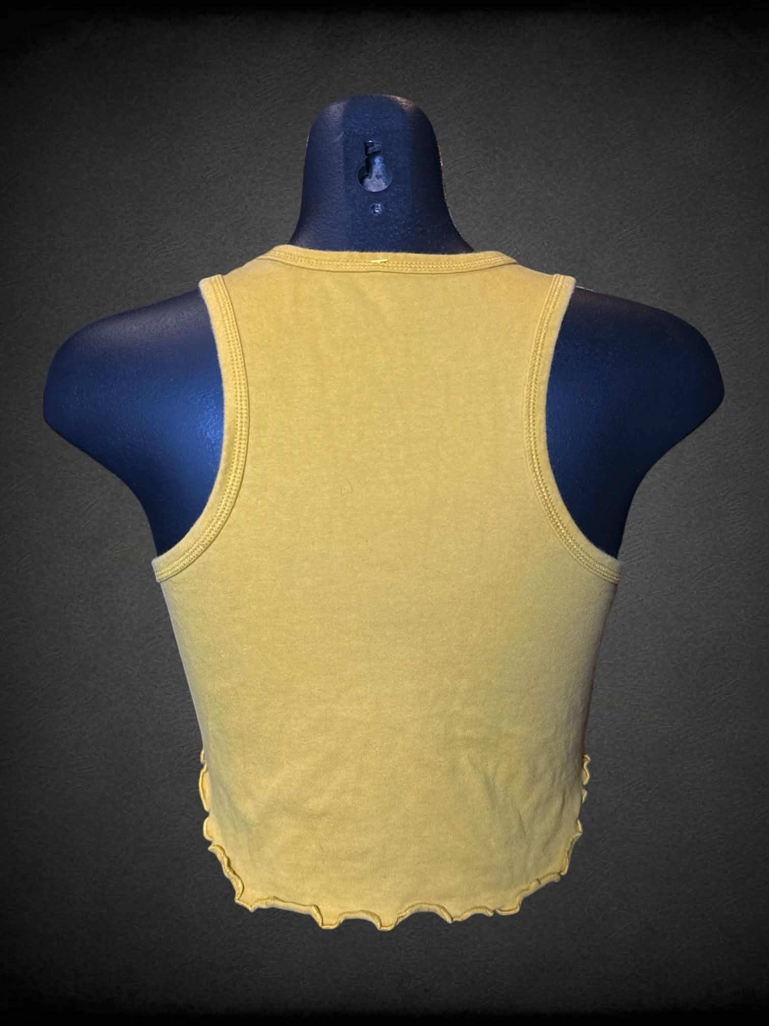 M Woodstock mustard yellow cropped tank top with “Make Love Not War” Woodstock graphic on front, and ruffle hem