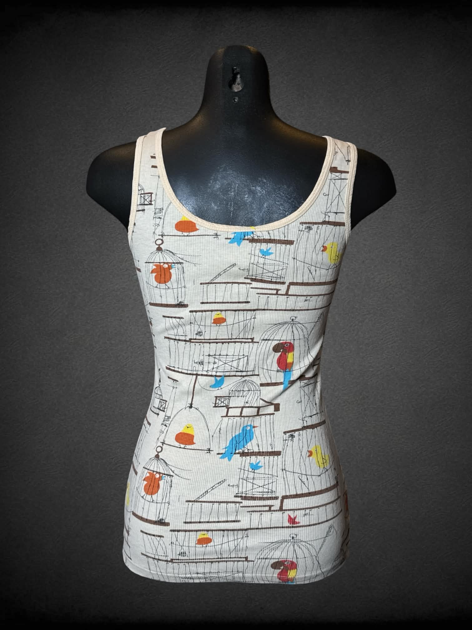 M Delia’s tan ribbed tank top with bird pattern