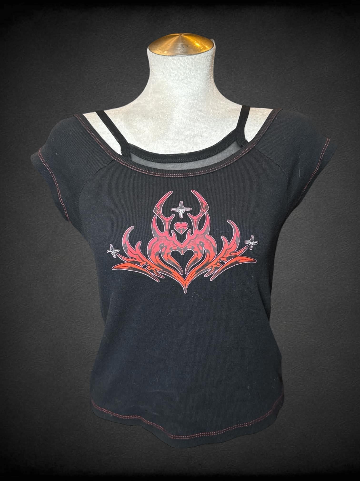 L Vitriole black ribbed baby tee with red tribal heart graphic on front