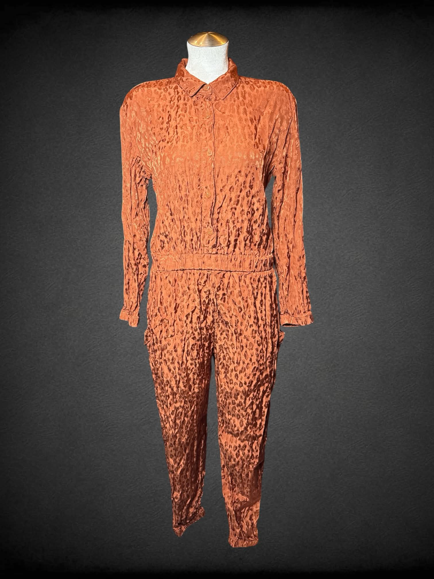 L On 34th burnt orange jumpsuit with leopard print pattern, buttons on front, and pockets