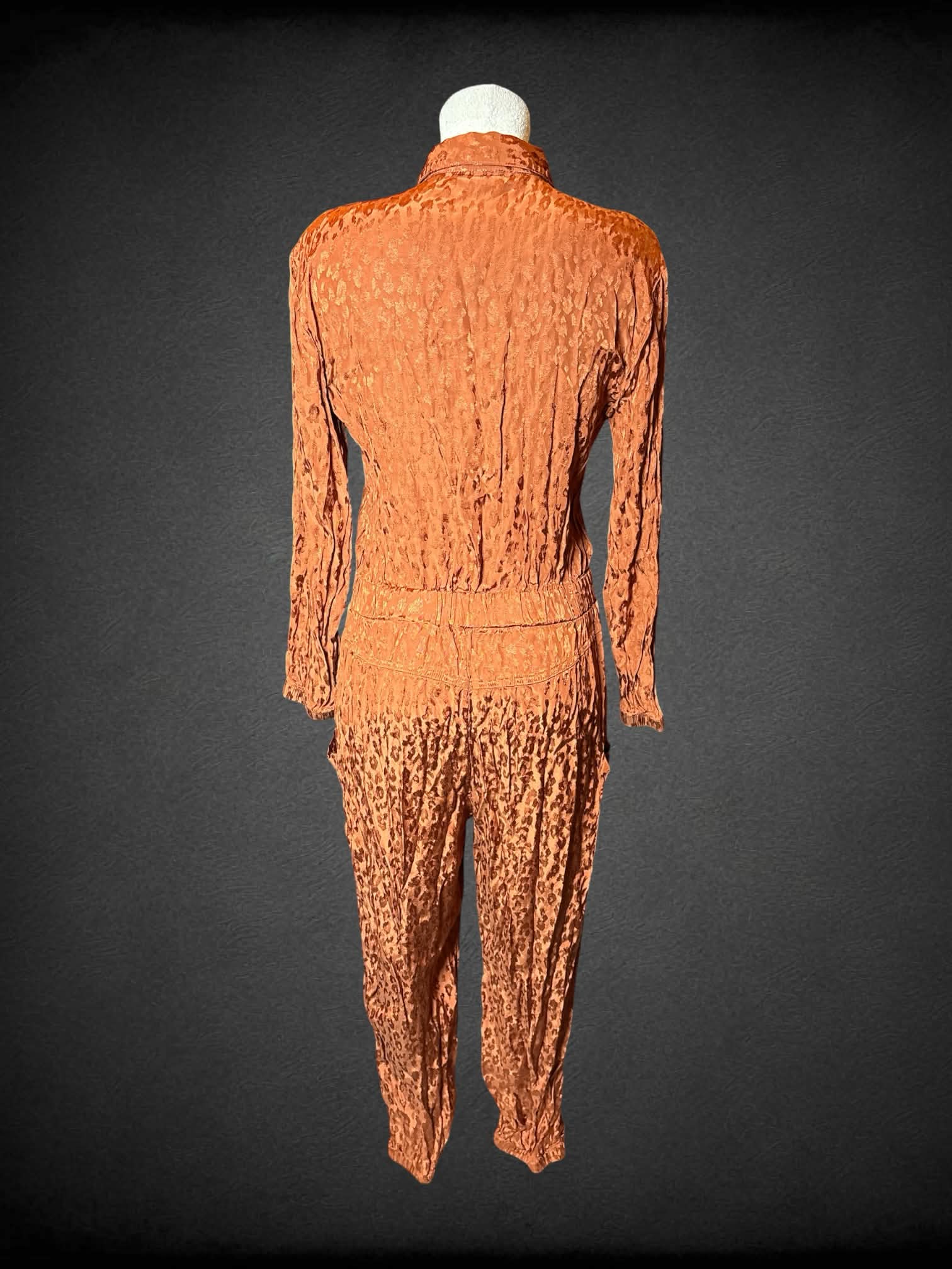 L On 34th burnt orange jumpsuit with leopard print pattern, buttons on front, and pockets