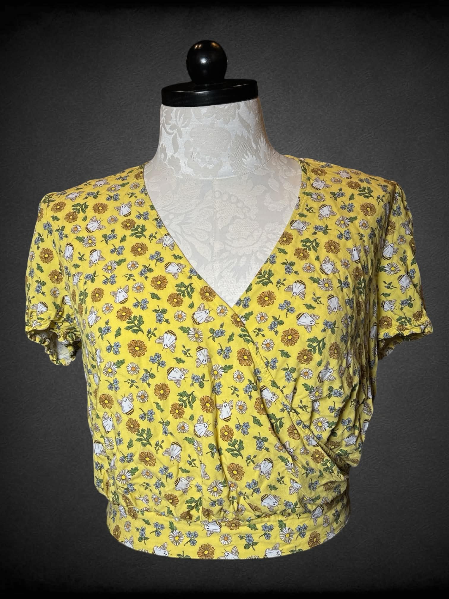 XL Thorn & Fable yellow cropped blouse with floral and ghost bee pattern, tie on back, and asymmetrical cut on front