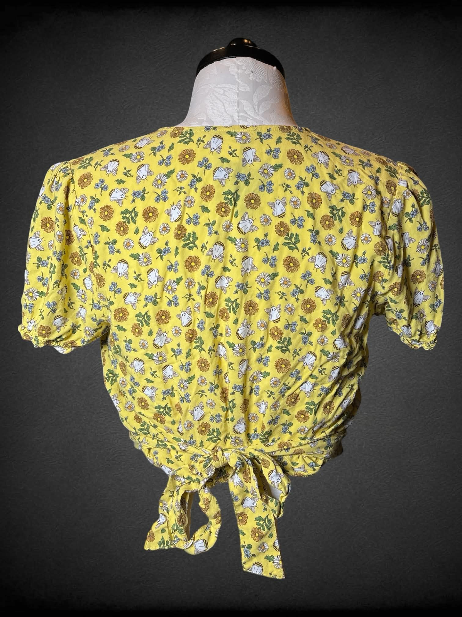 XL Thorn & Fable yellow cropped blouse with floral and ghost bee pattern, tie on back, and asymmetrical cut on front