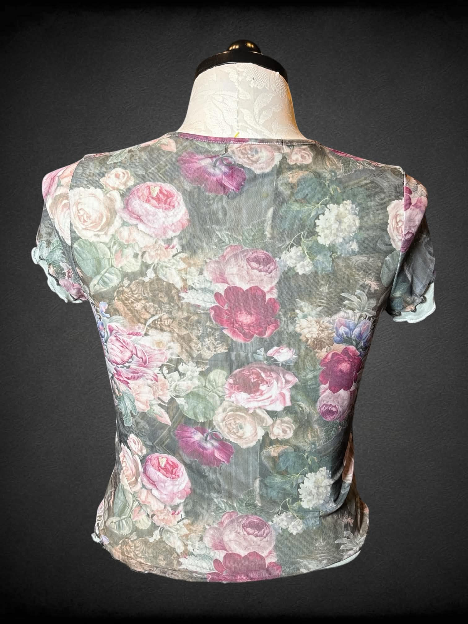 1X Almost Famous green sheer fitted top with floral pattern, and ruffle hem