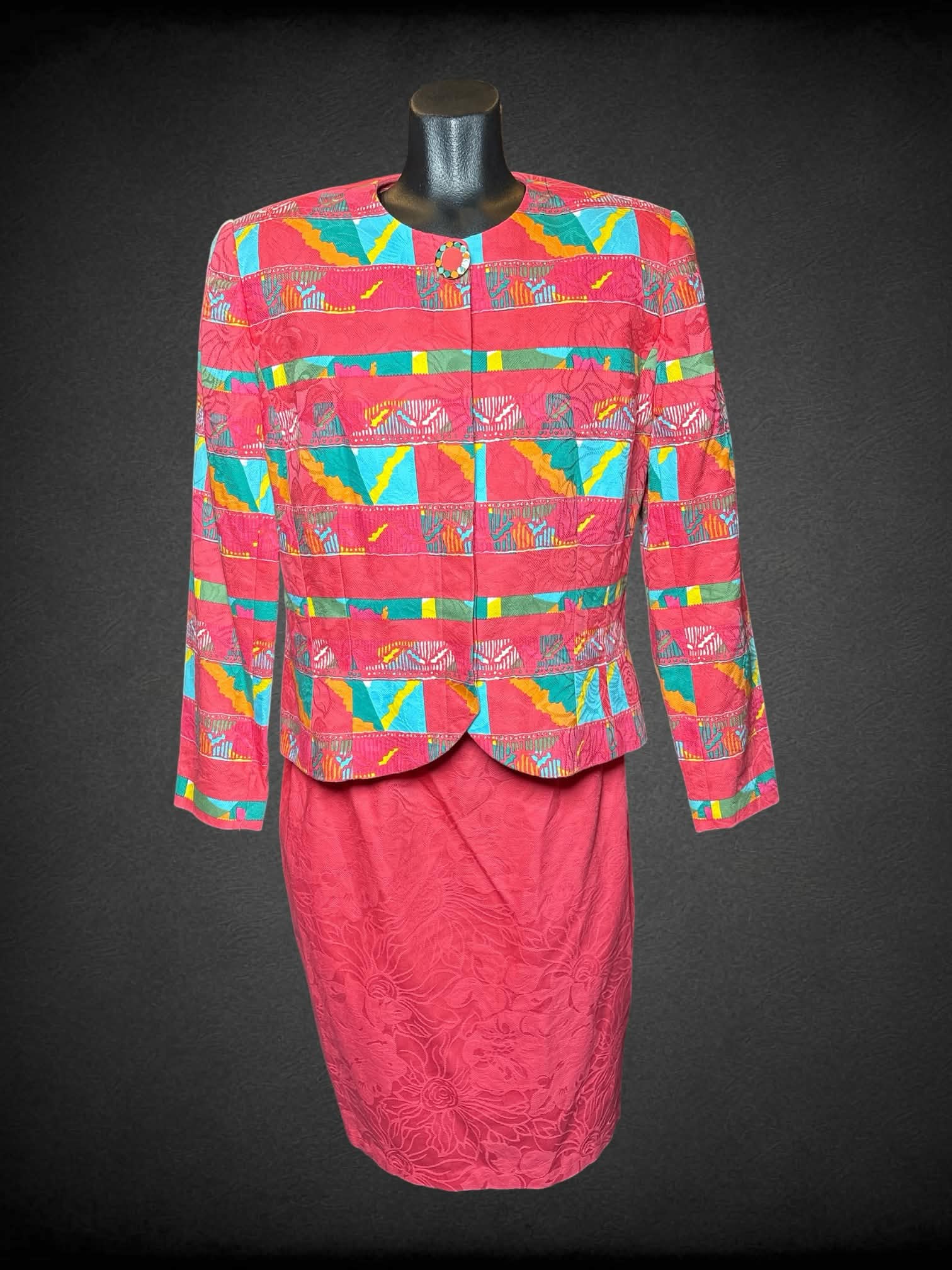 M Anne Crimmins For Umi Collections vintage two-piece set: hot pink blazer with padded shoulders, colorful pattern and buttons on front. Skirt has embroidered flower pattern, zipper and button on back