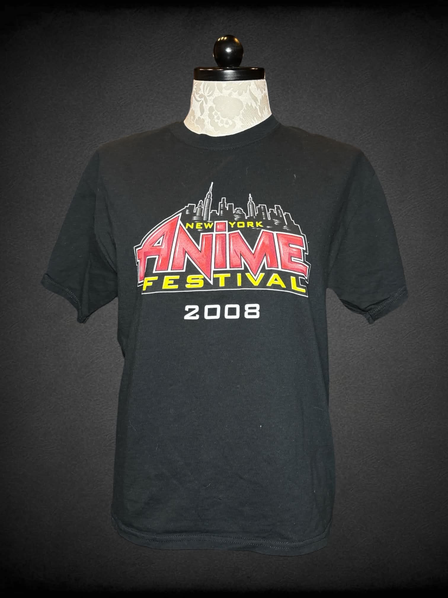 1X Gildan black t shirt with “New York Anime Festival” graphic on front, and Japanese writing on back