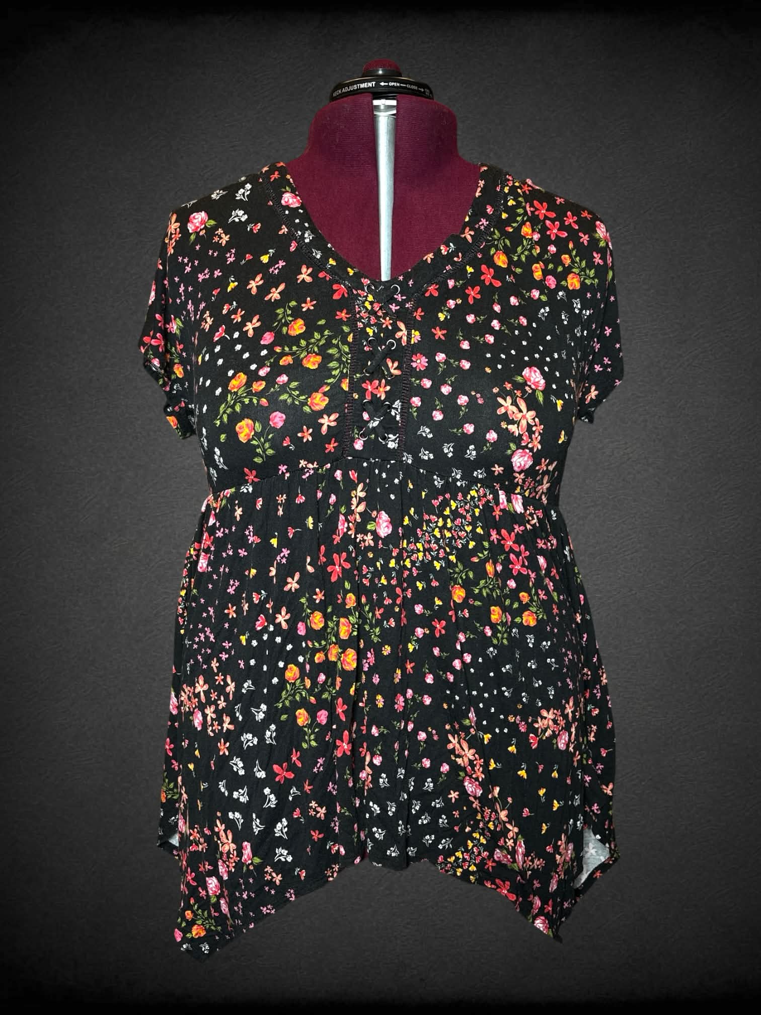 2X Torrid black shirt with colorful floral pattern, empire waist seem, and laces on front