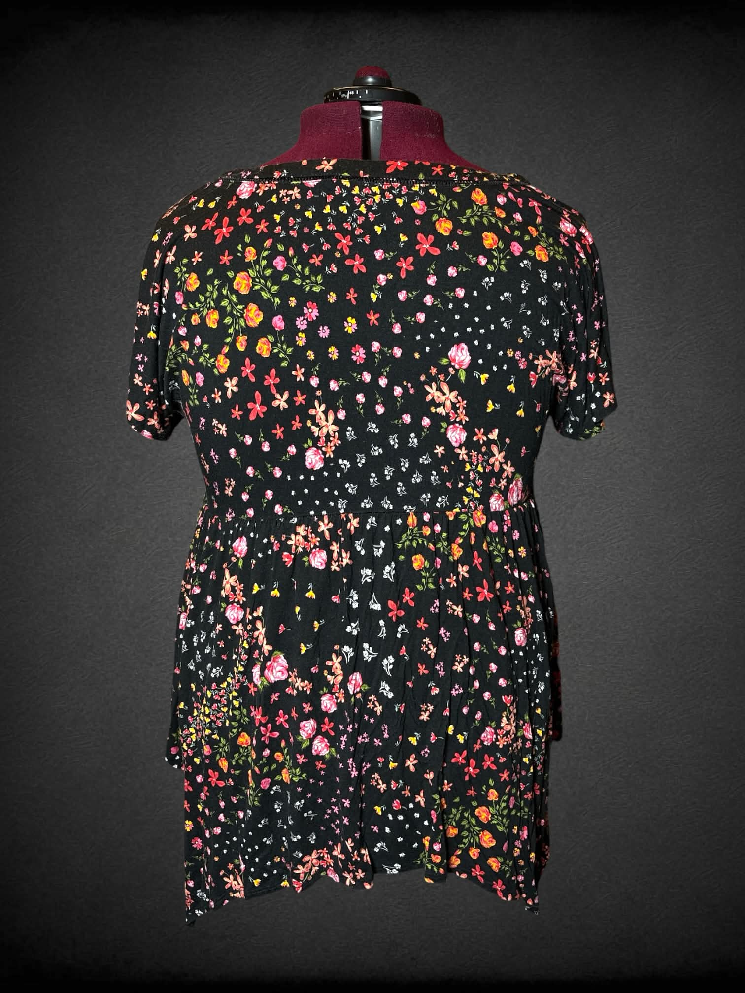 2X Torrid black shirt with colorful floral pattern, empire waist seem, and laces on front