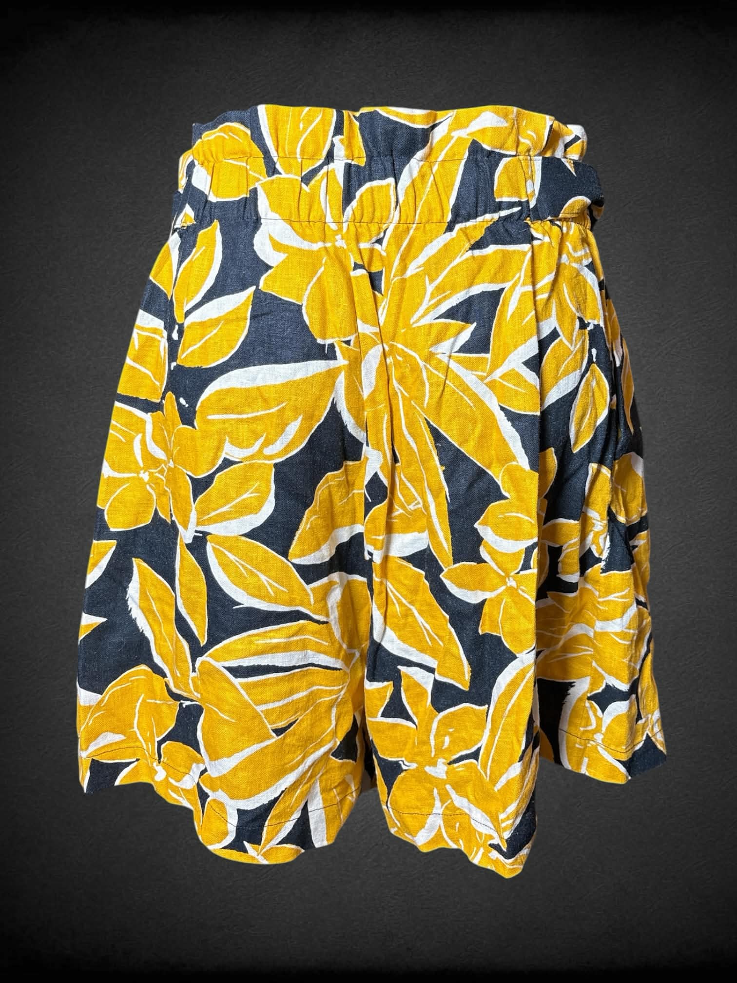 S Who What Wear black high-waisted shorts with yellow floral pattern, decorative buttons and stretch waist