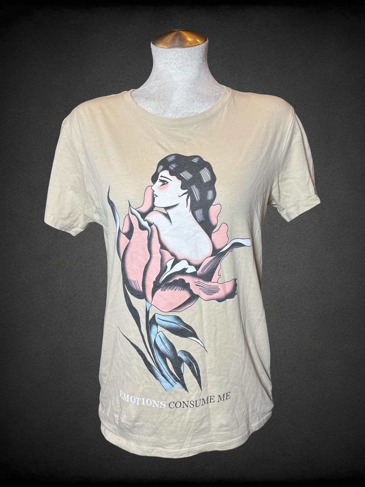 L Teen Hearts tan t shirt with girl & flower traditional art graphic with “Emotions consume me” writing on front