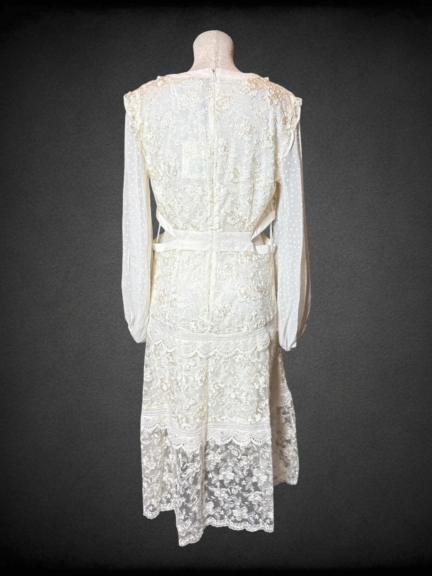 L Alexis NWT white lace long-sleeve dress with cutout design on sides, floral embroidery, and zipper on back