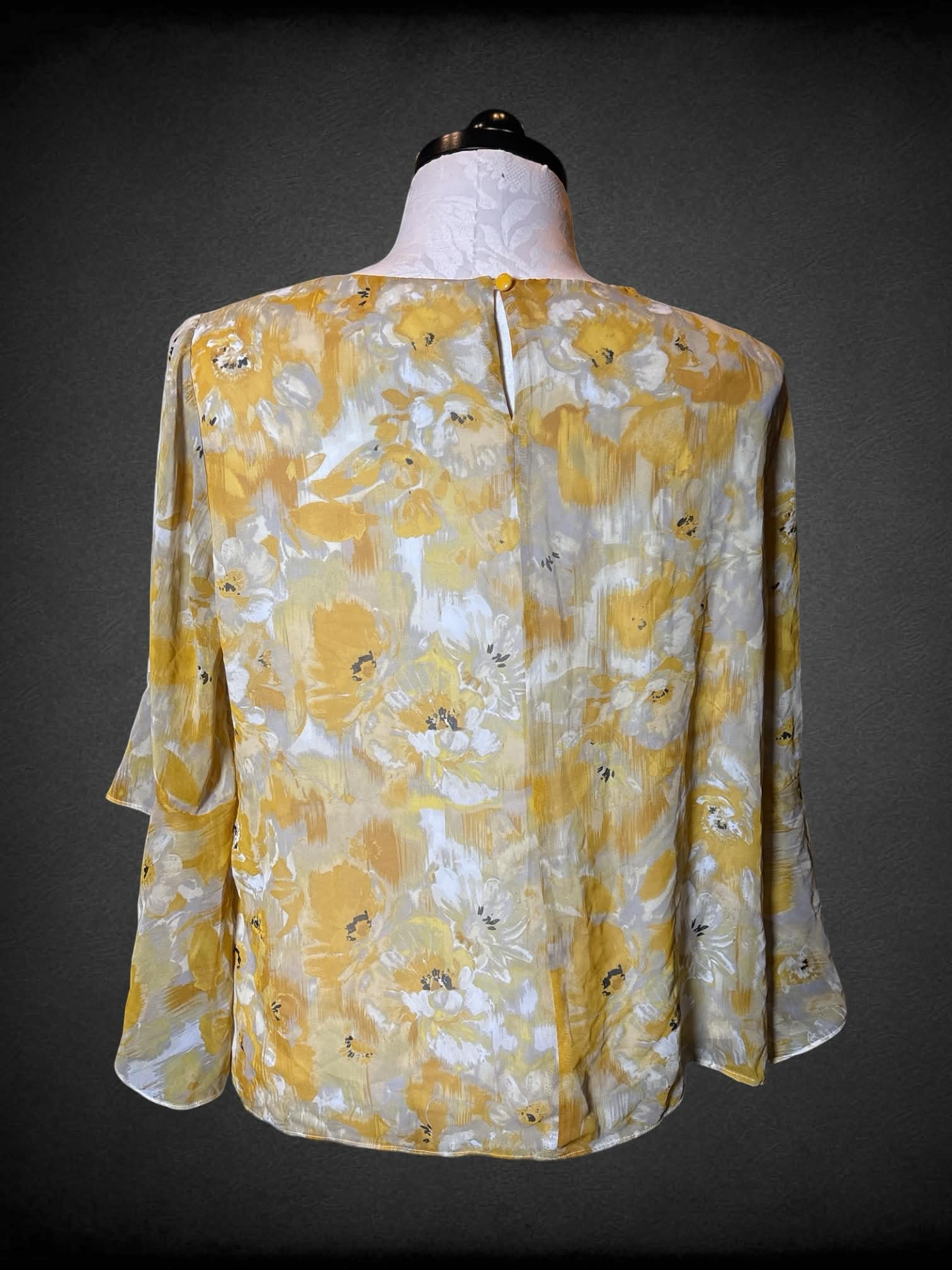 1X Kasper flowy yellow blouse with floral design, bell sleeves, and button on back