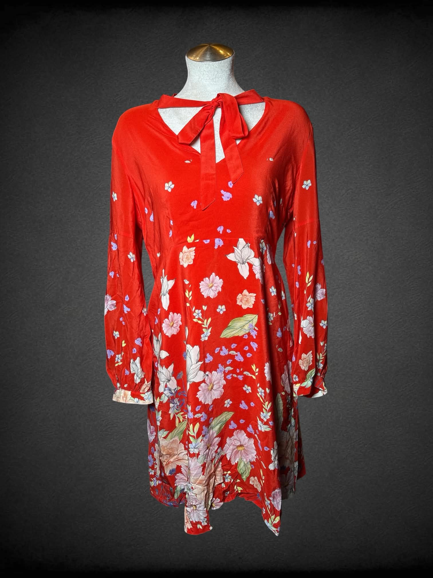 L Anthropologie red long-sleeve dress with tie around neck, floral design, and zipper on side